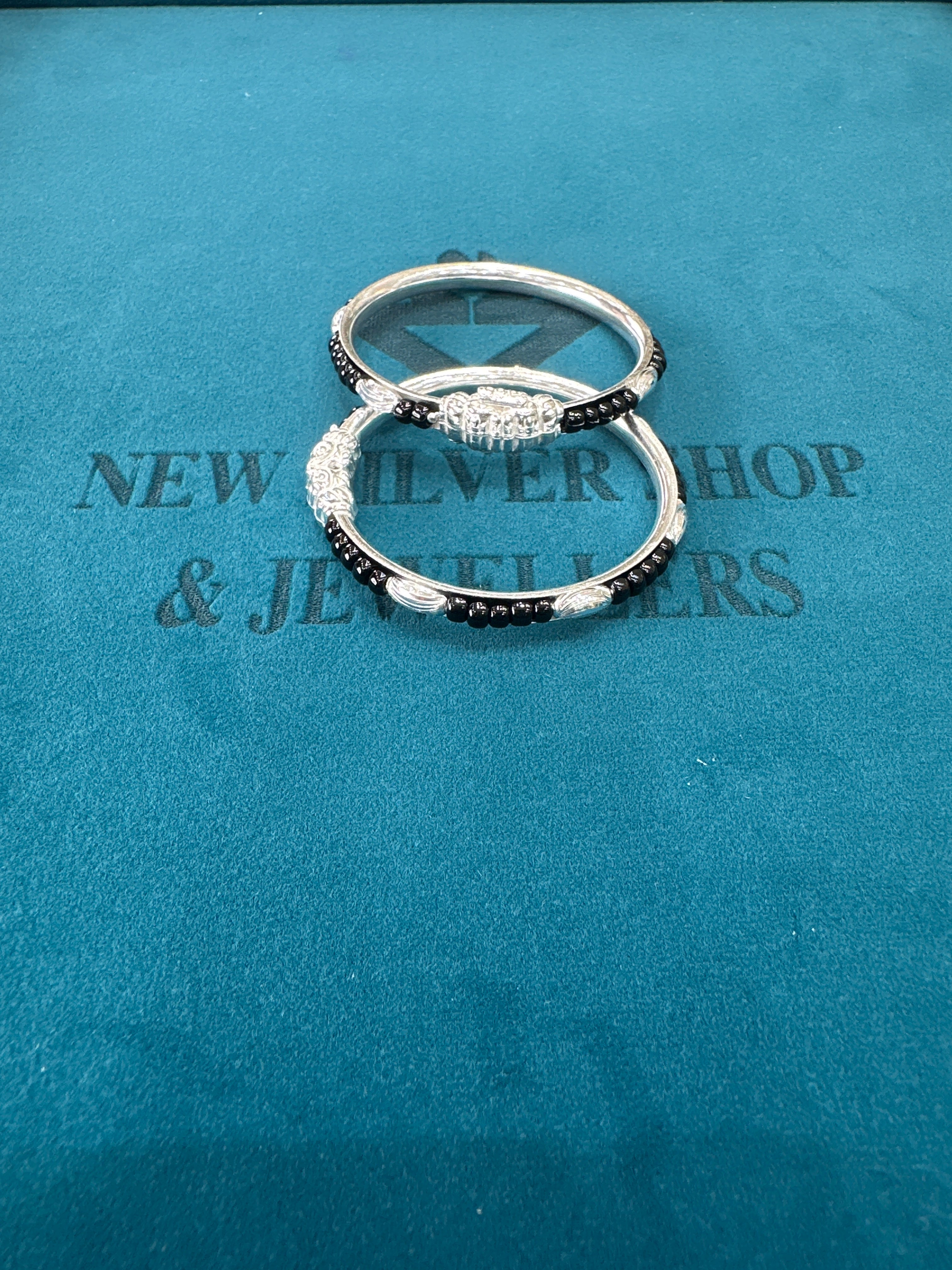 Silver baby bangles with black beads
