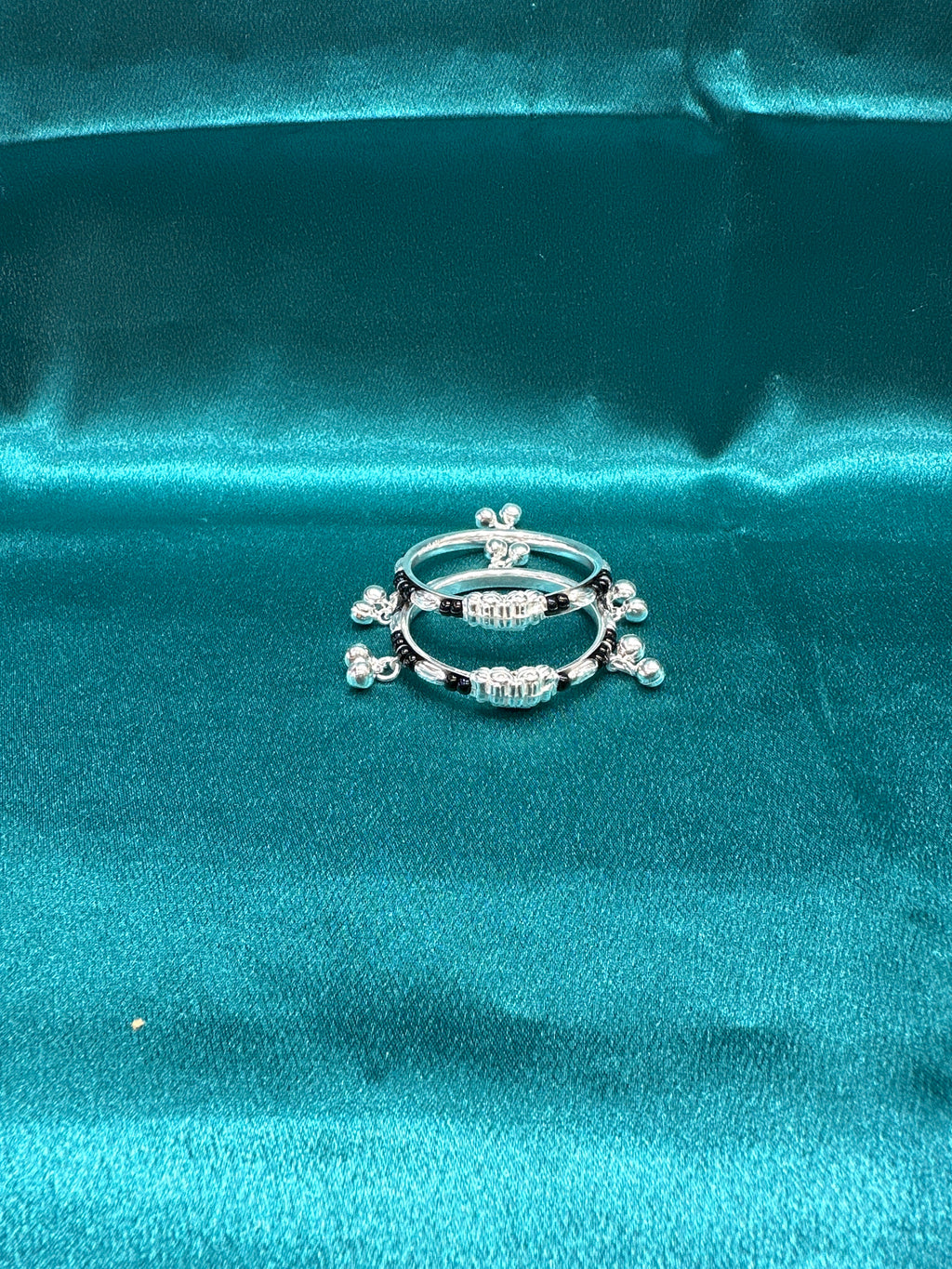 Silver baby bangles with black beads and bells