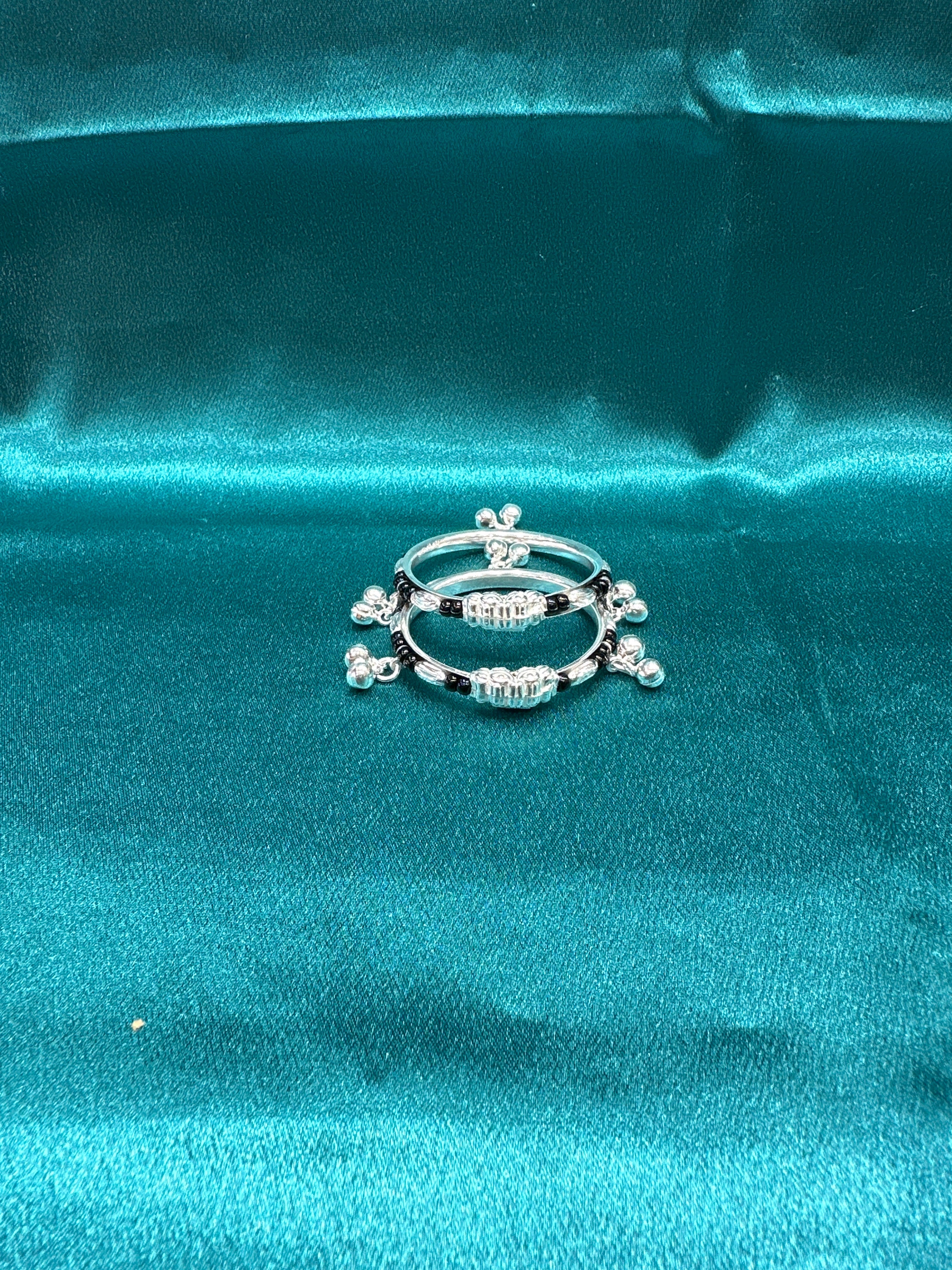 Silver baby bangles with black beads and bells