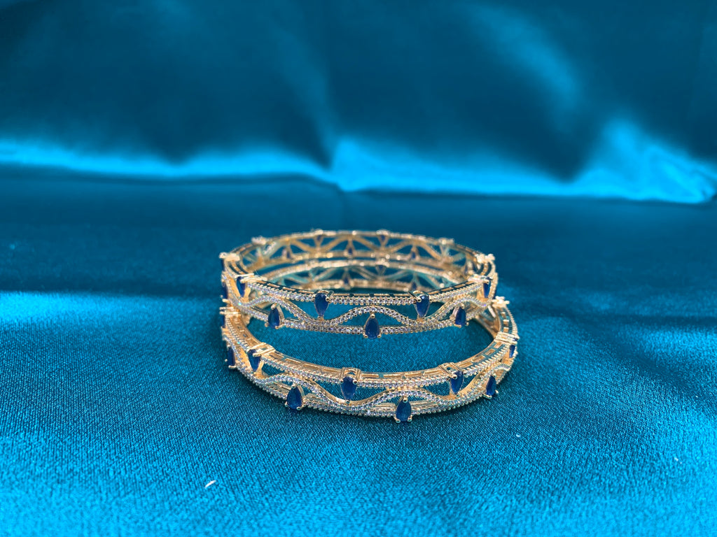 Dazzling gold plated silver bangles with tear drop blue CZ diamonds