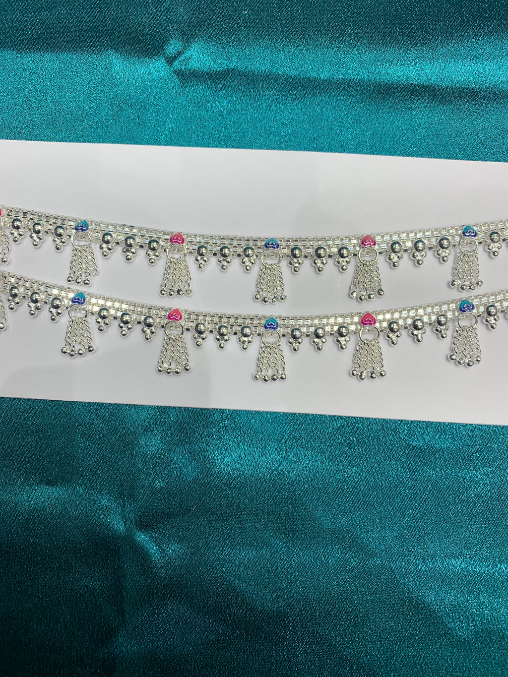Traditional silver anklets in blue and pink enamel and hanging bells
