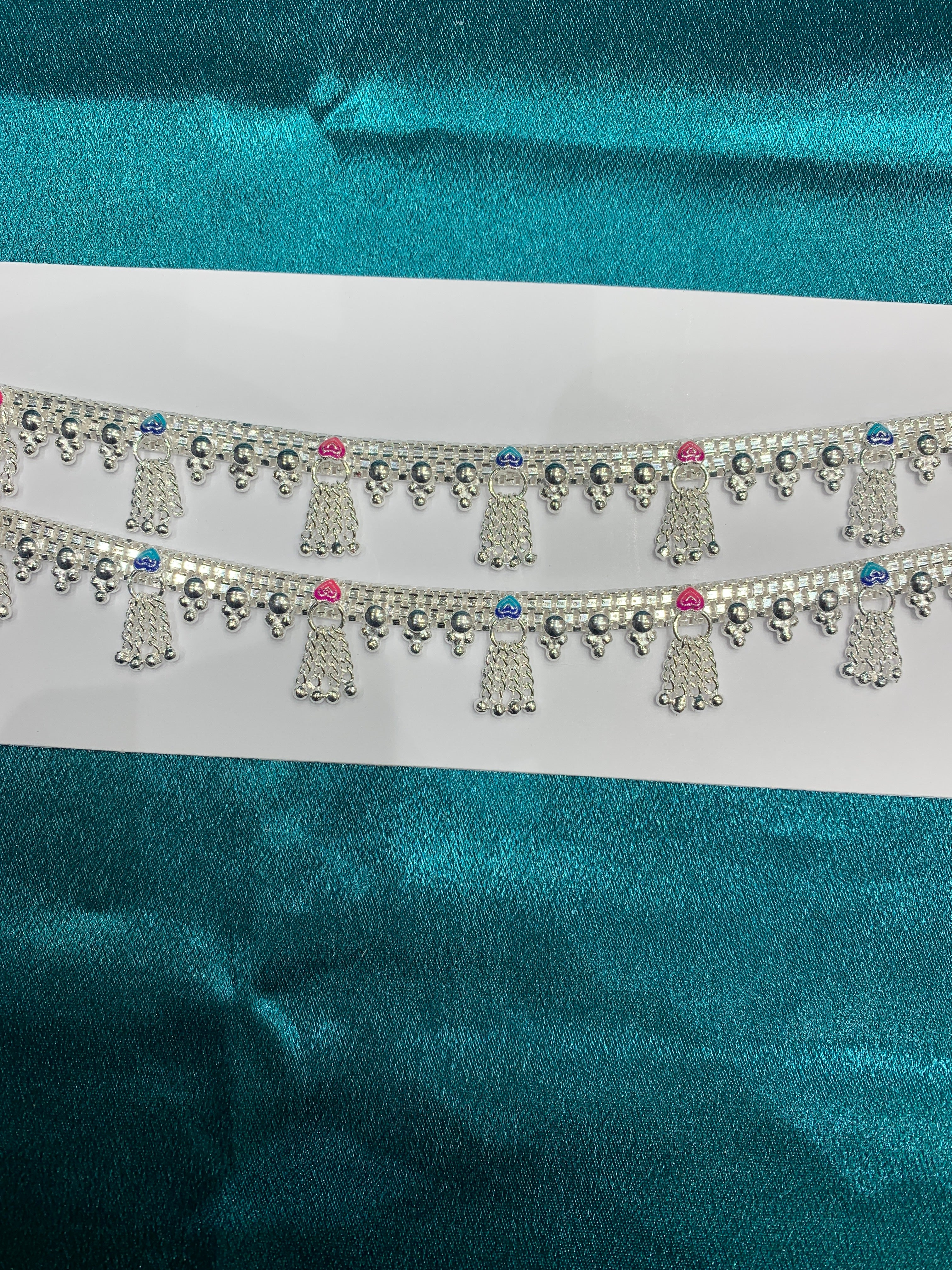 Traditional silver anklets in blue and pink enamel and hanging bells