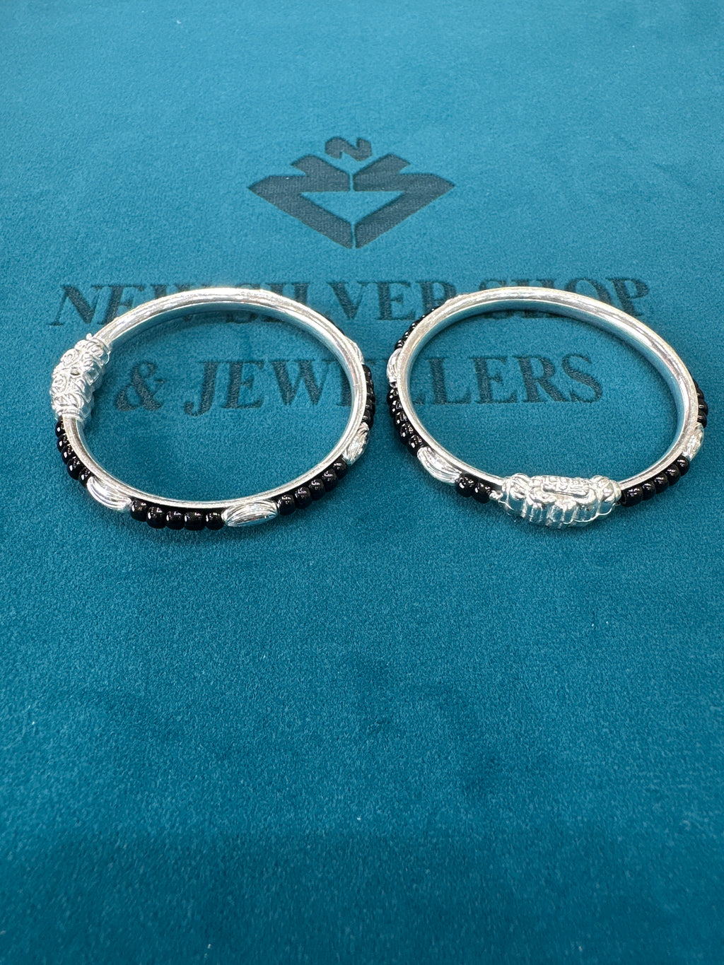 Silver baby bangles with black beads