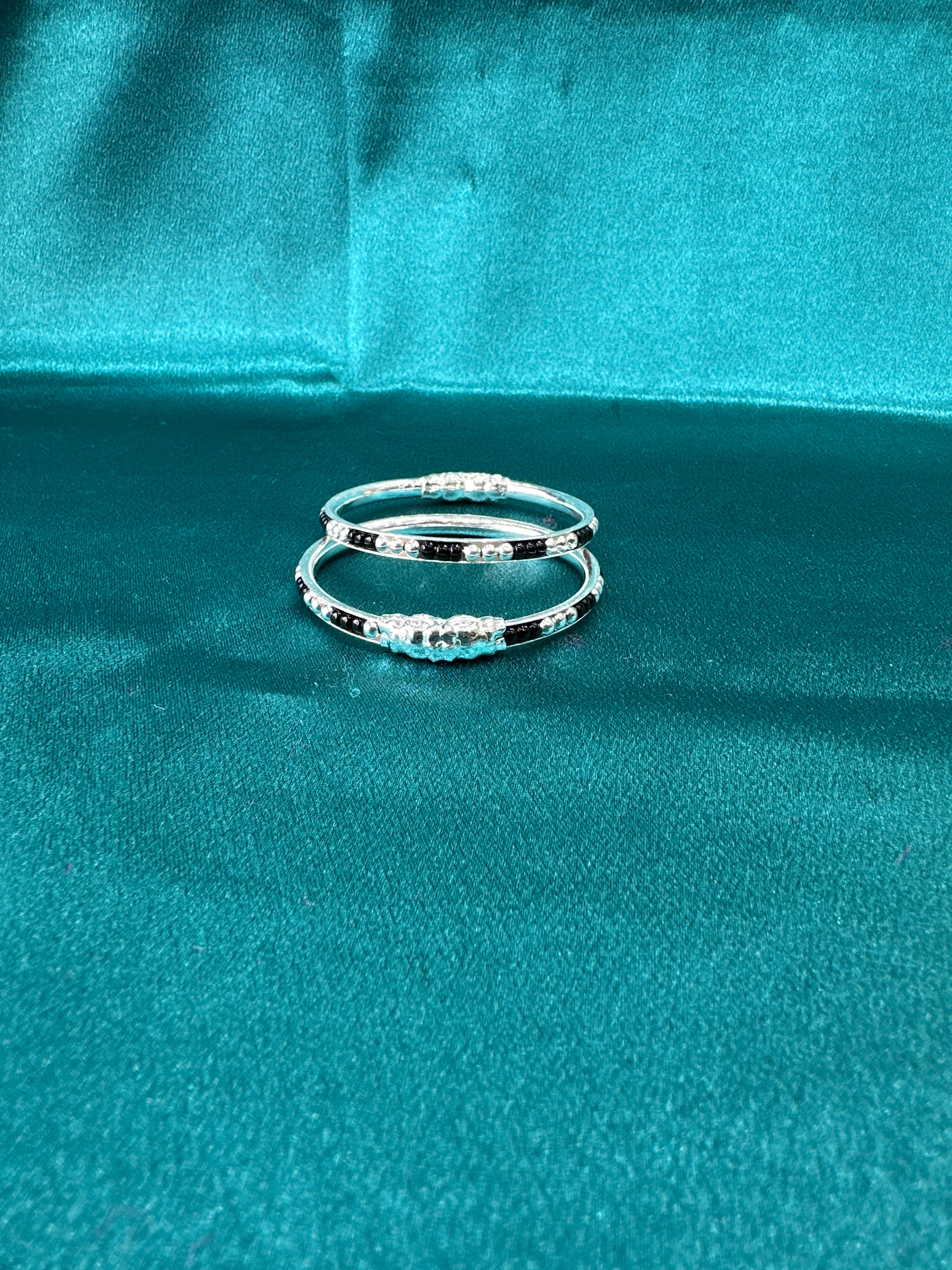Silver baby bangles with black beads