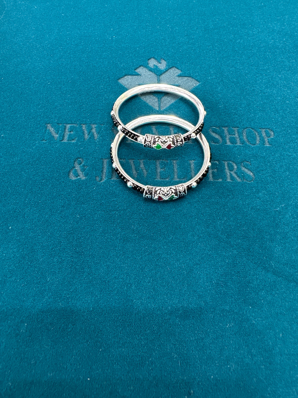 Silver baby bangles with black beads