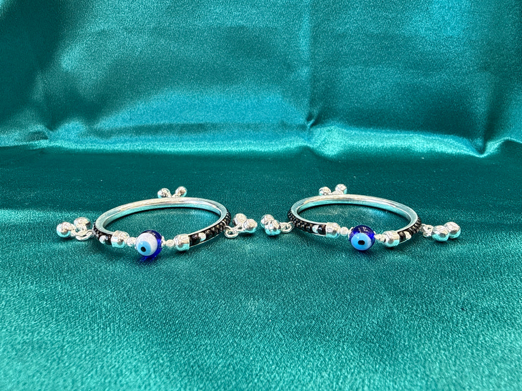 Silver baby bangles with black beads, evil eye and bells