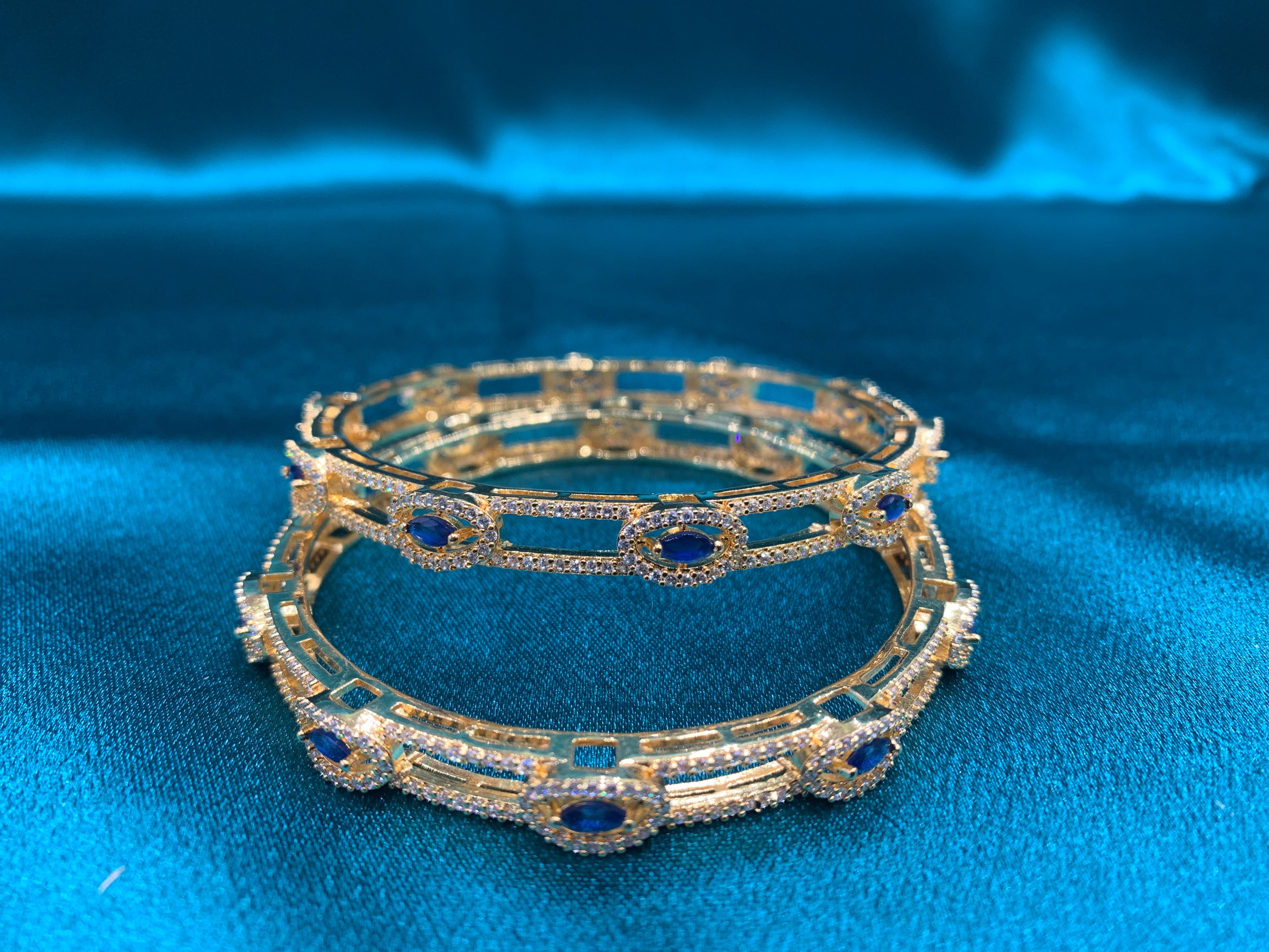 Dazzling gold plated silver bangles with blue stones and white CZ diamonds