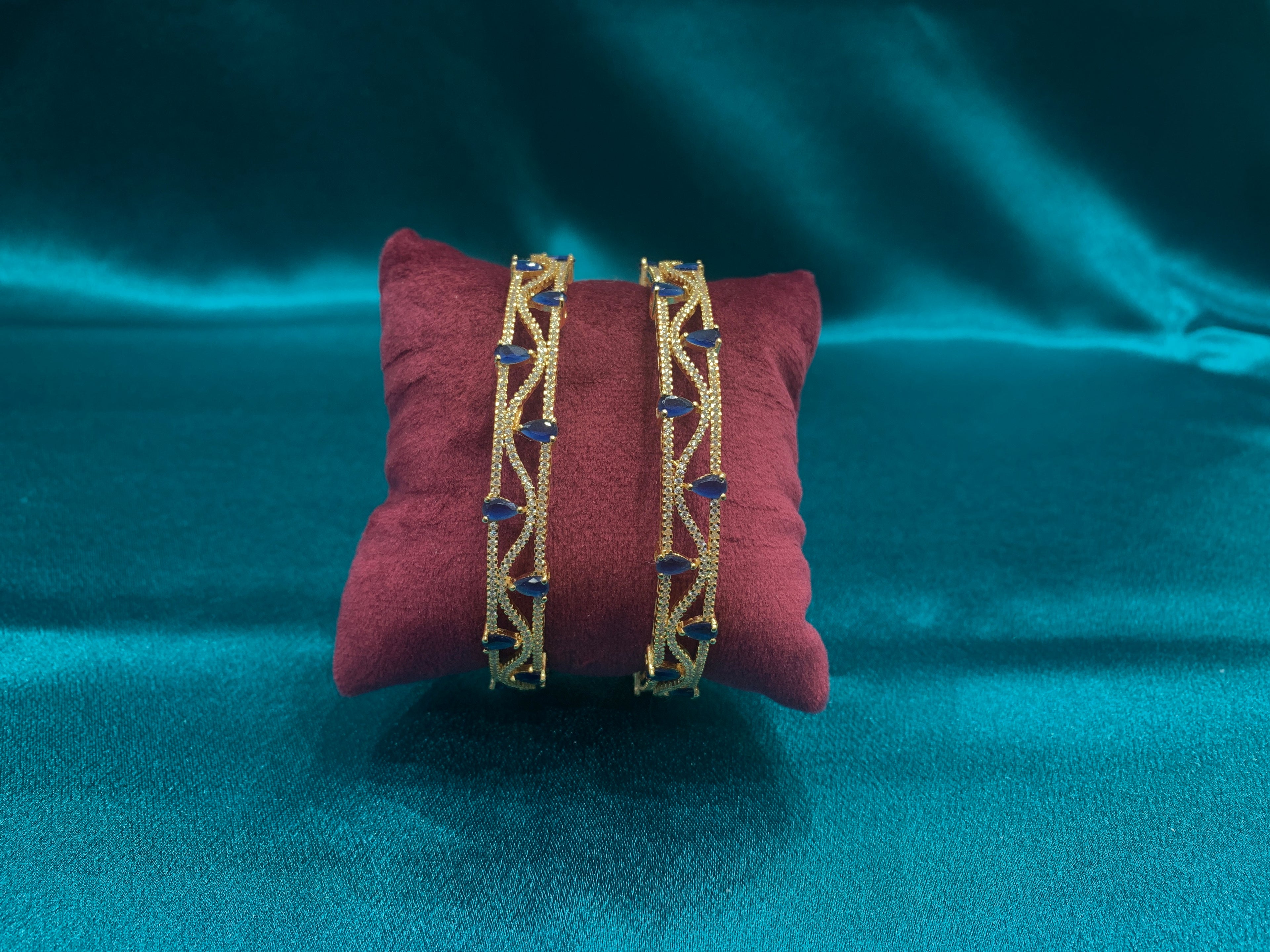 Dazzling gold plated silver bangles with tear drop blue CZ diamonds