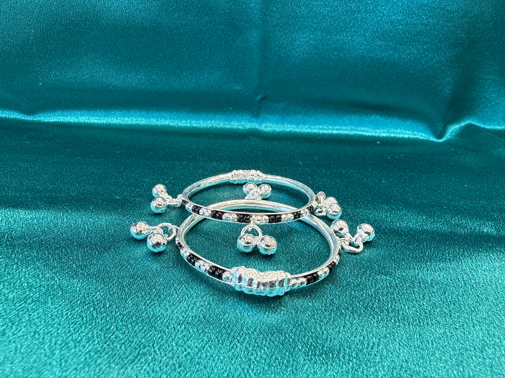 Silver baby bangles with black beads and bells