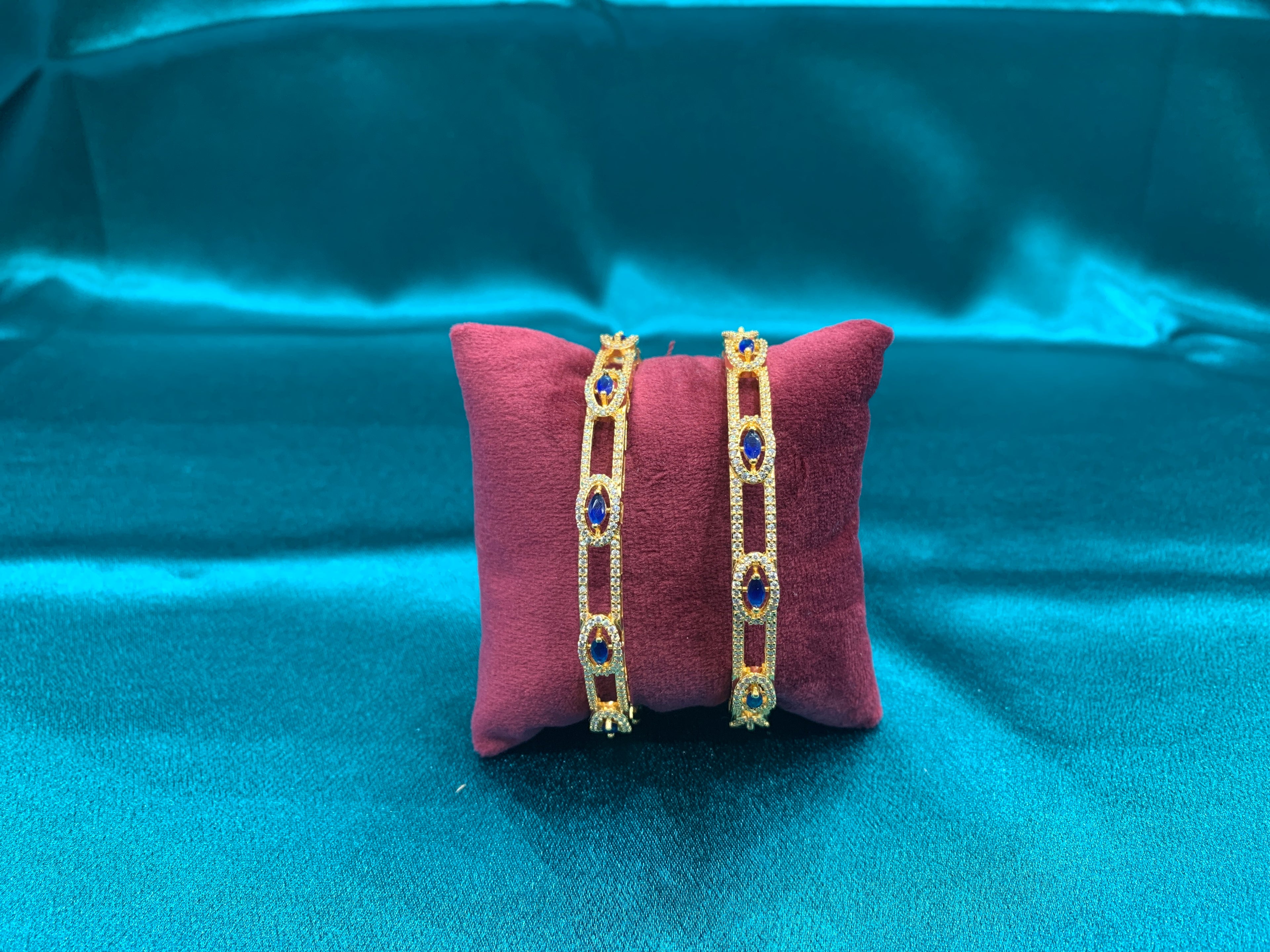Dazzling gold plated silver bangles with blue stones and white CZ diamonds