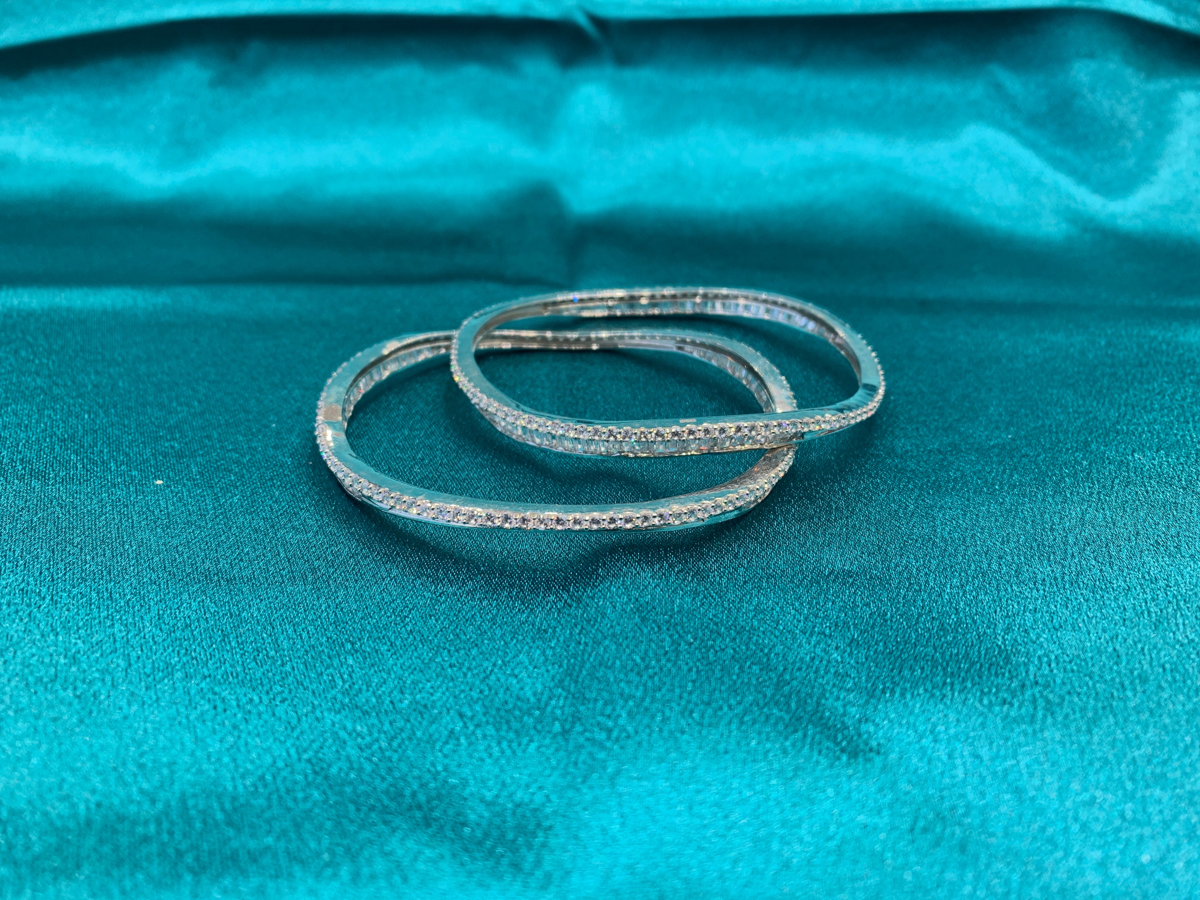 Elegant CZ diamond silver bangles in wavy design