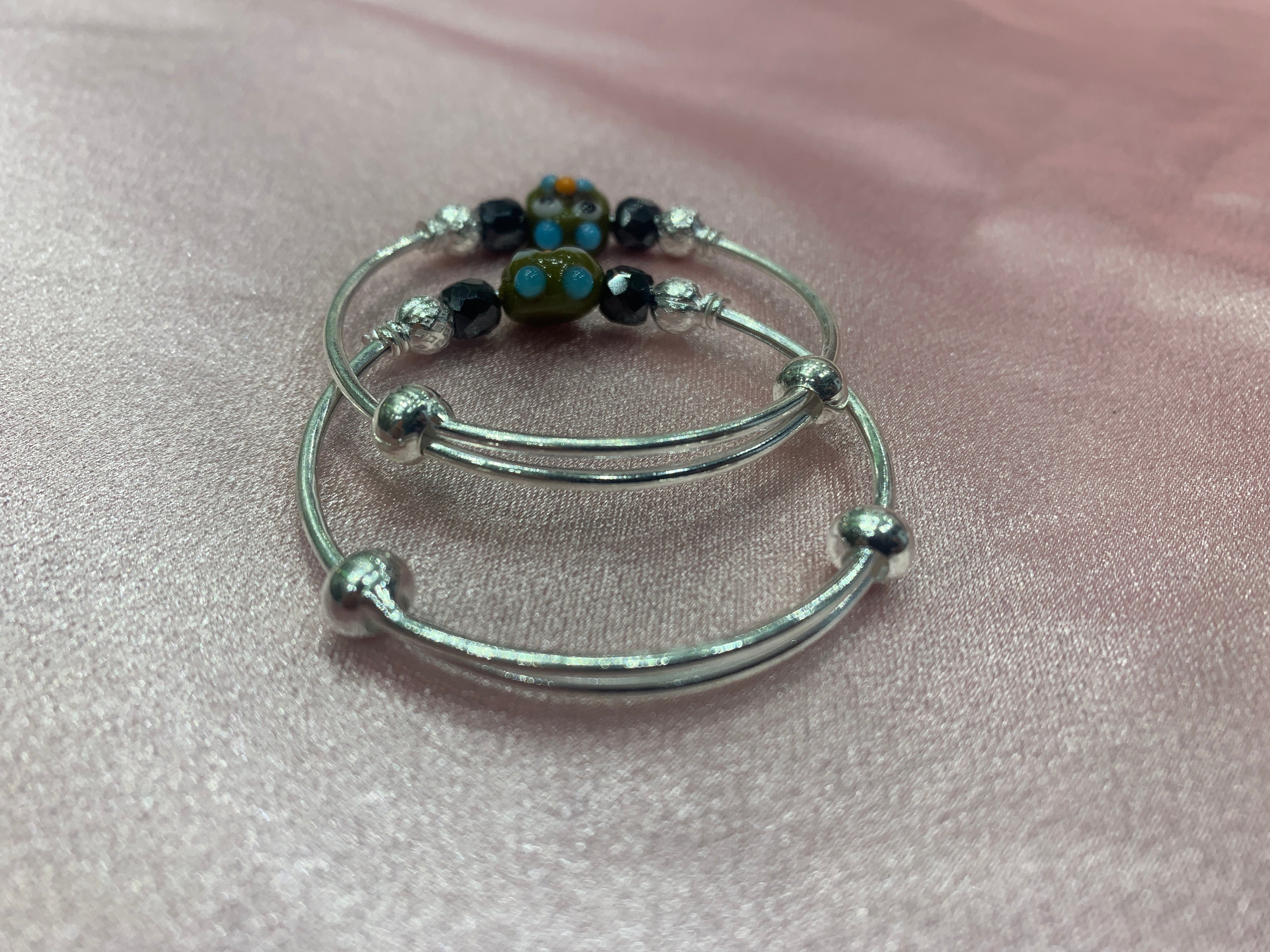 Silver baby bangles with black beads and angry bird