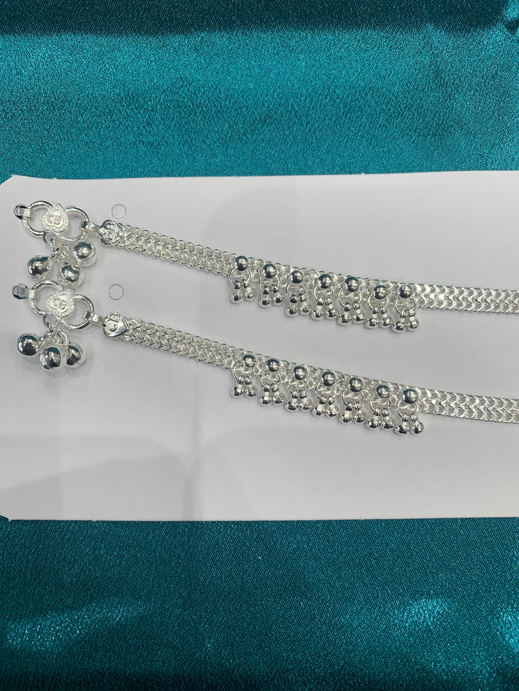 Traditional silver anklets with hanging bells in sequence