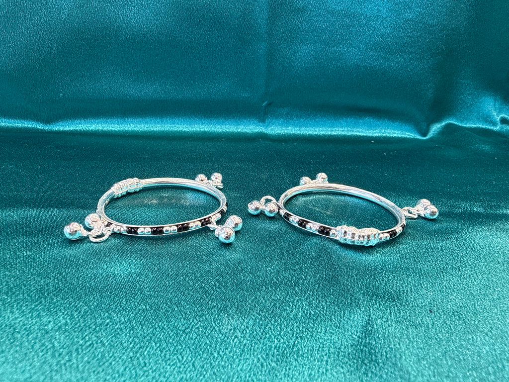 Silver baby bangles with black beads and bells