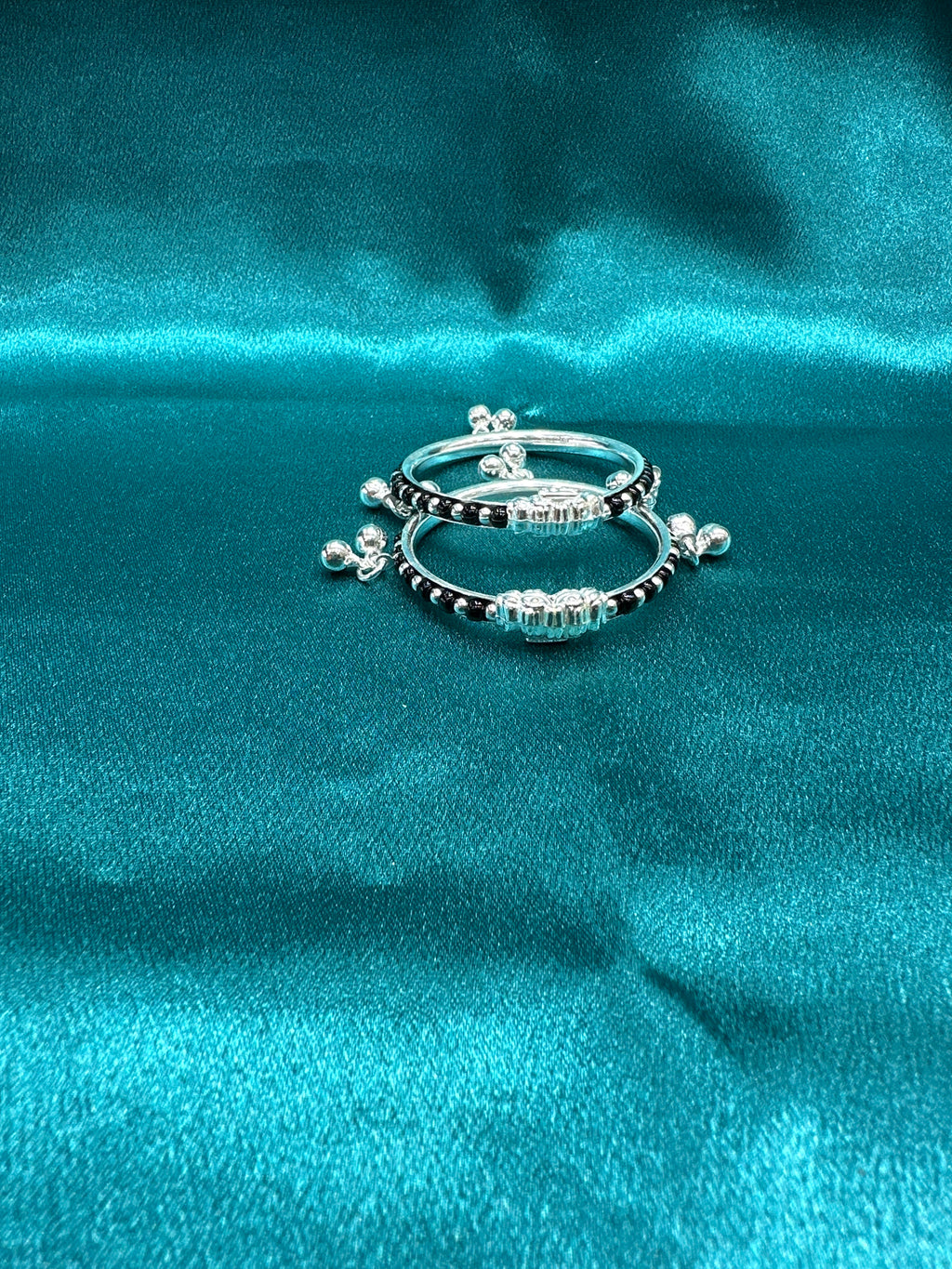 Silver baby bangles with black beads and bells
