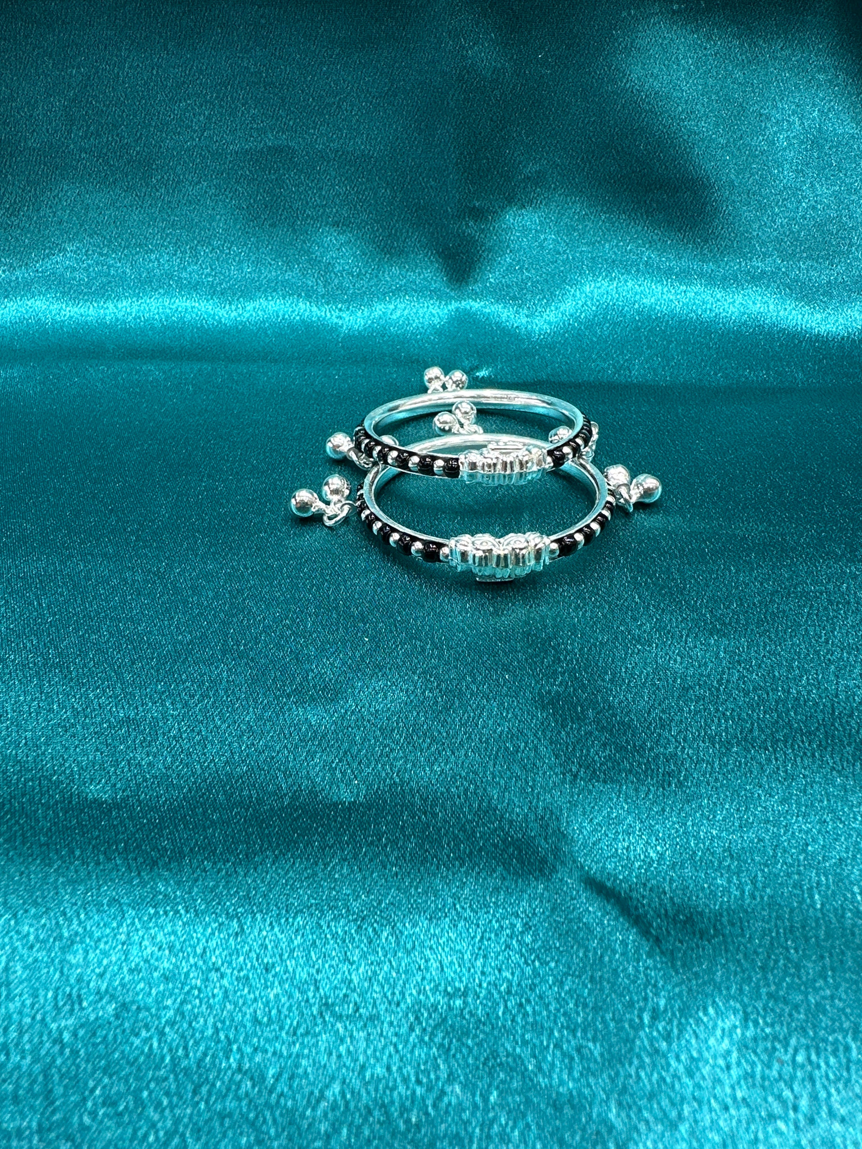 Silver baby bangles with black beads and bells