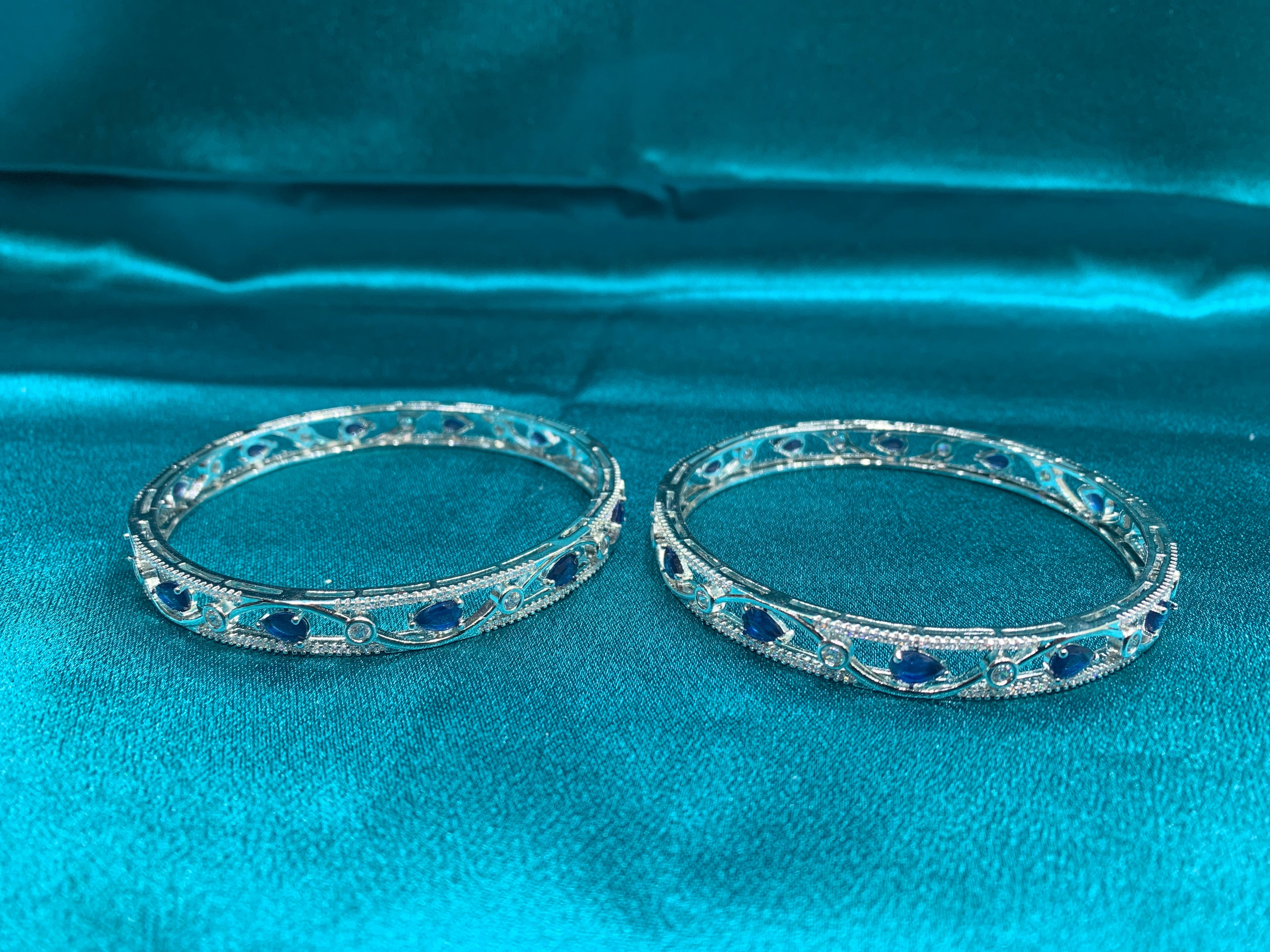 Elegant CZ diamond silver bangles with blue tear drop cut stones