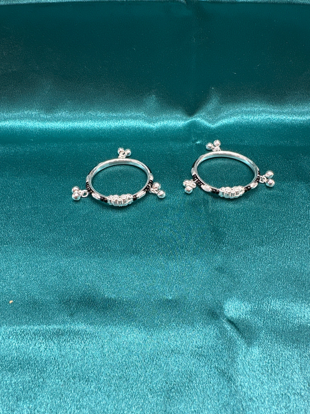 Silver baby bangles with black beads and bells