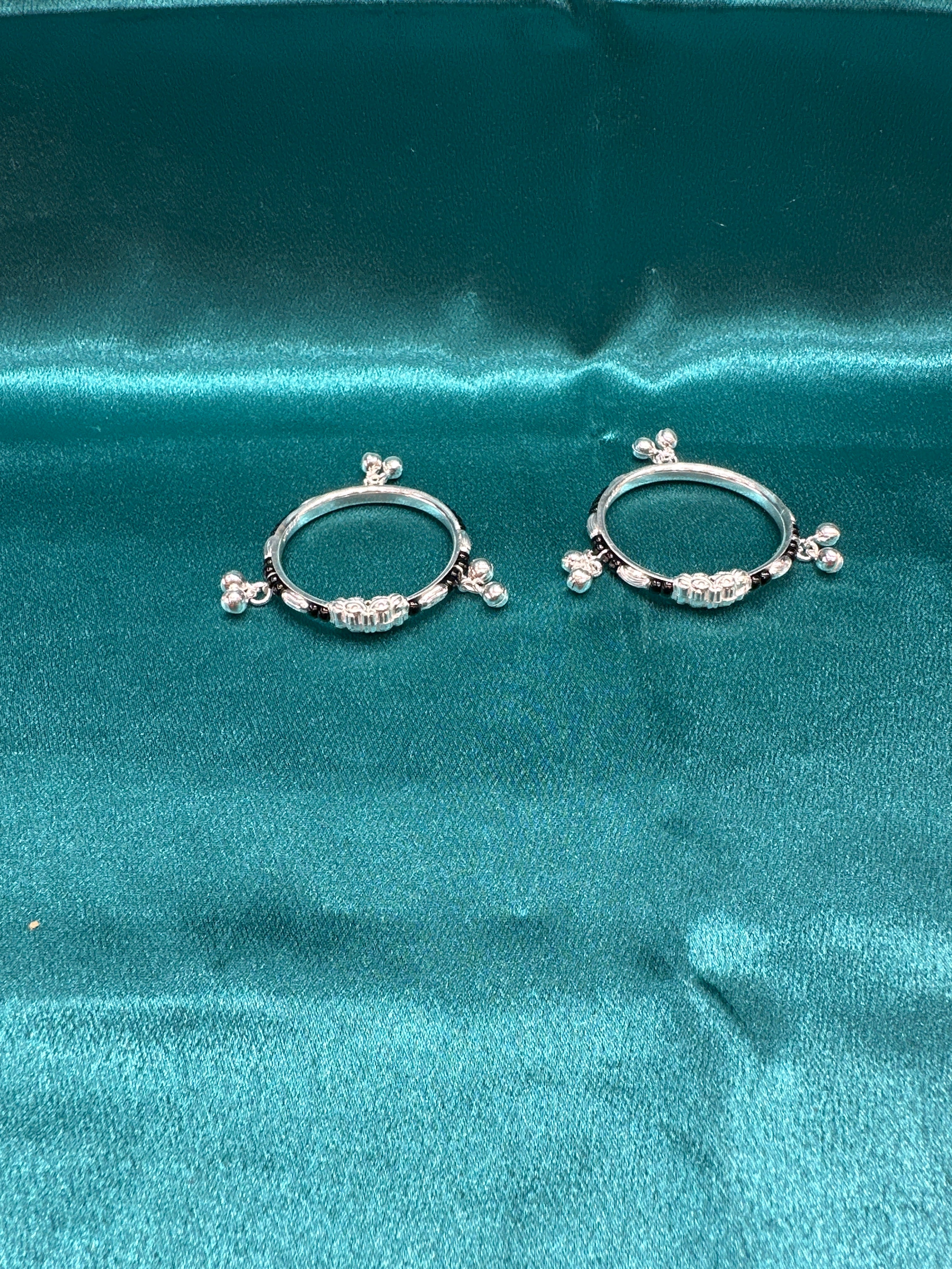 Silver baby bangles with black beads and bells