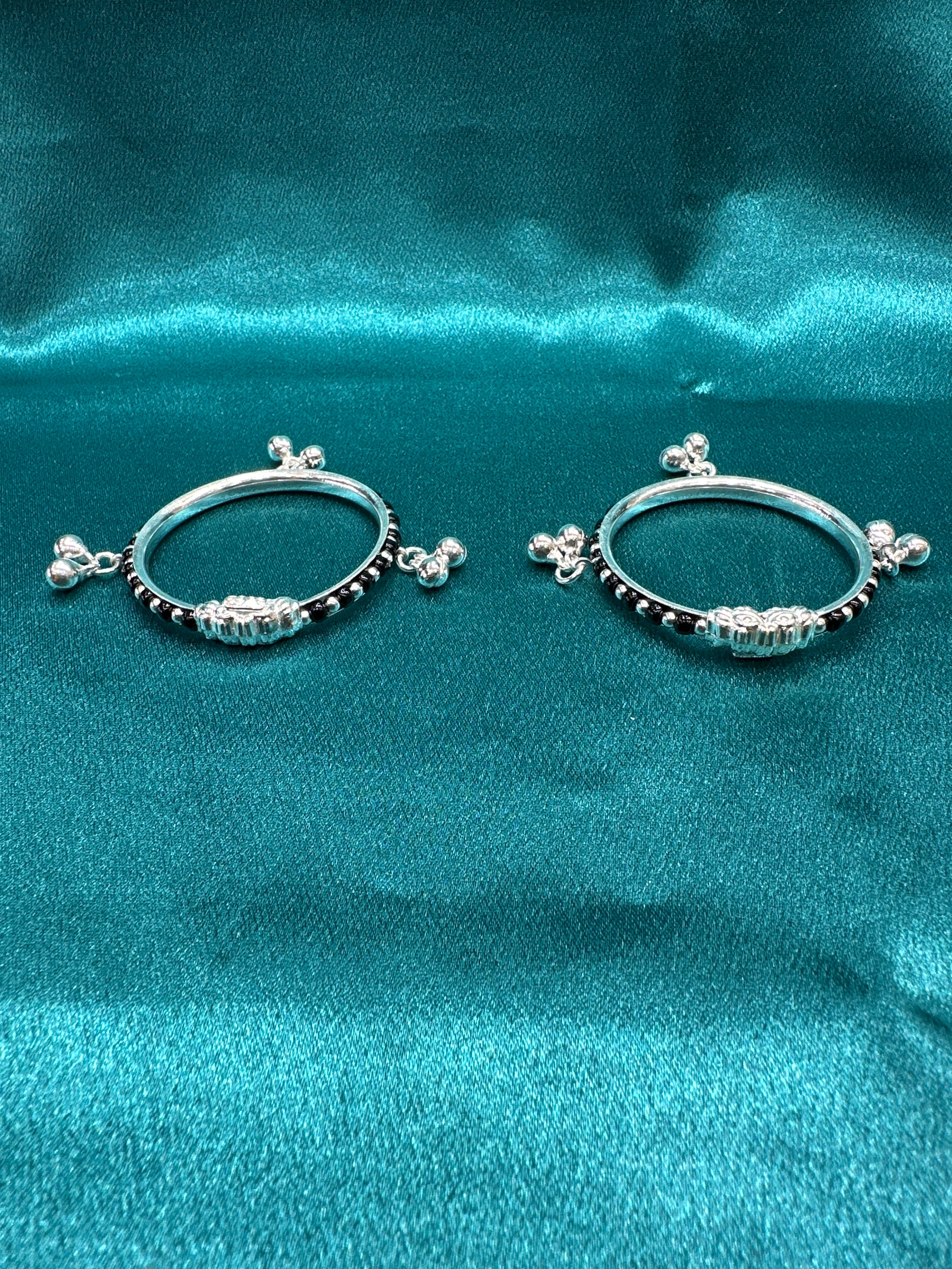 Silver baby bangles with black beads and bells