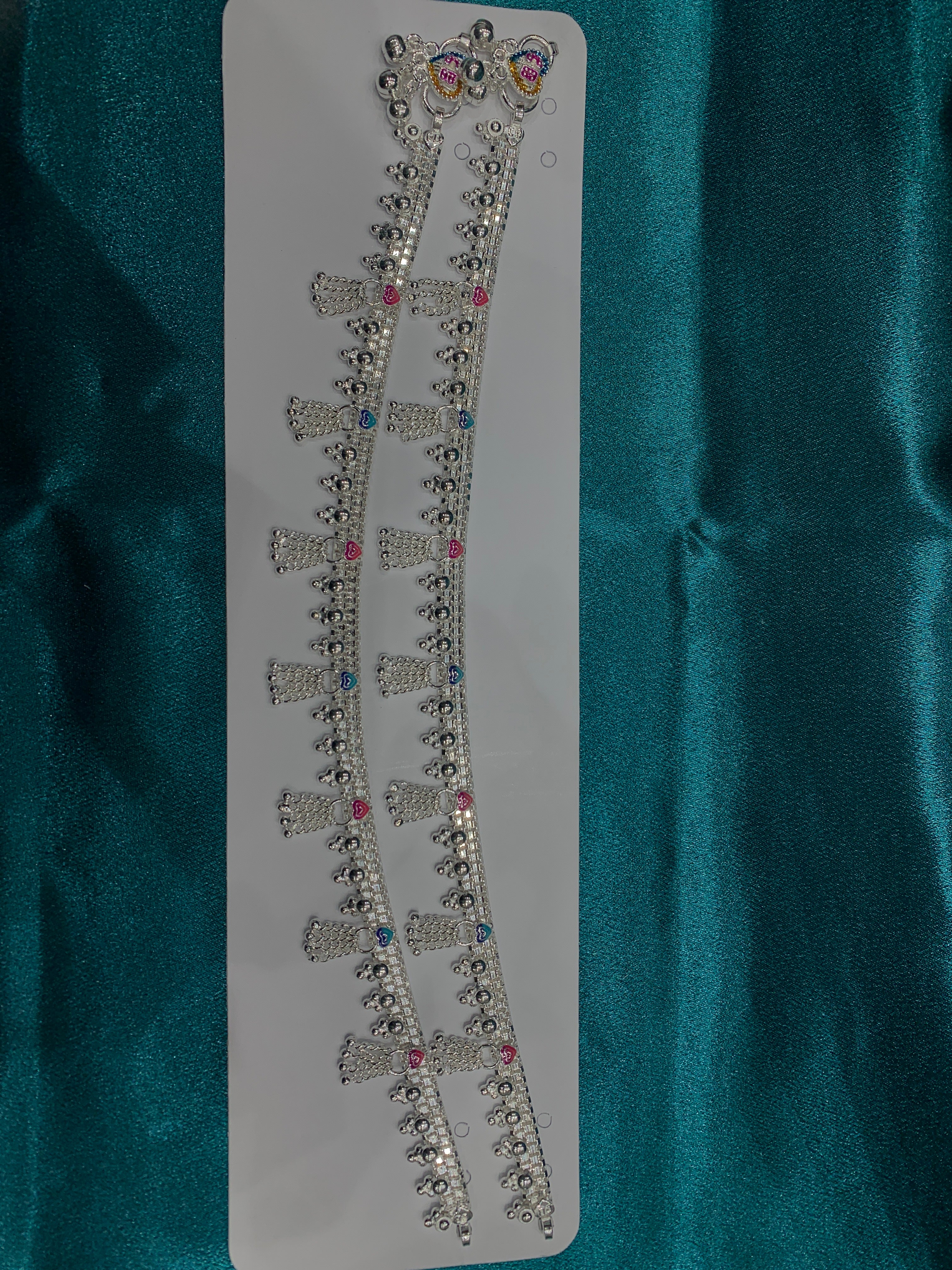 Traditional silver anklets in blue and pink enamel and hanging bells