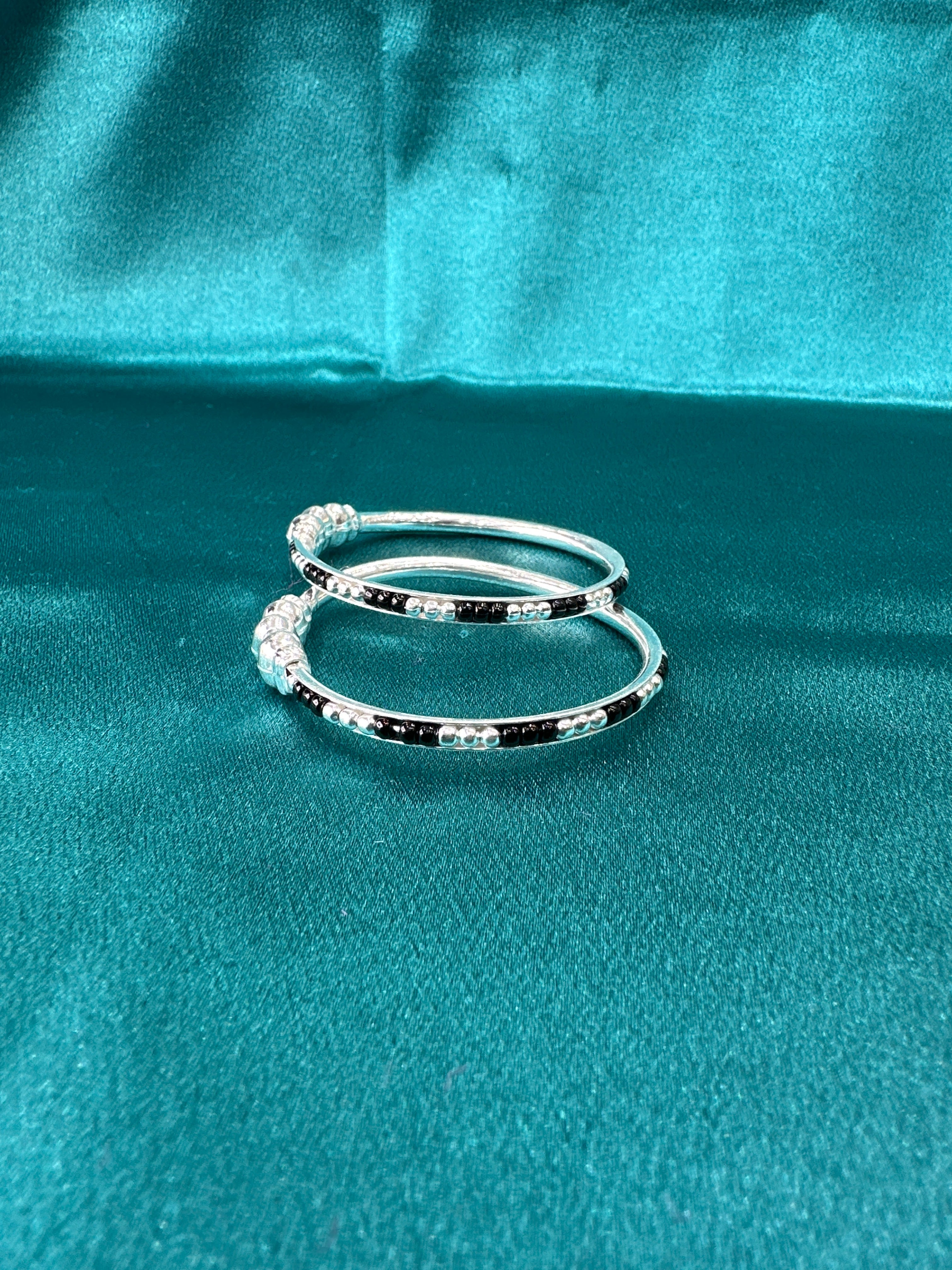 Silver baby bangles with black beads