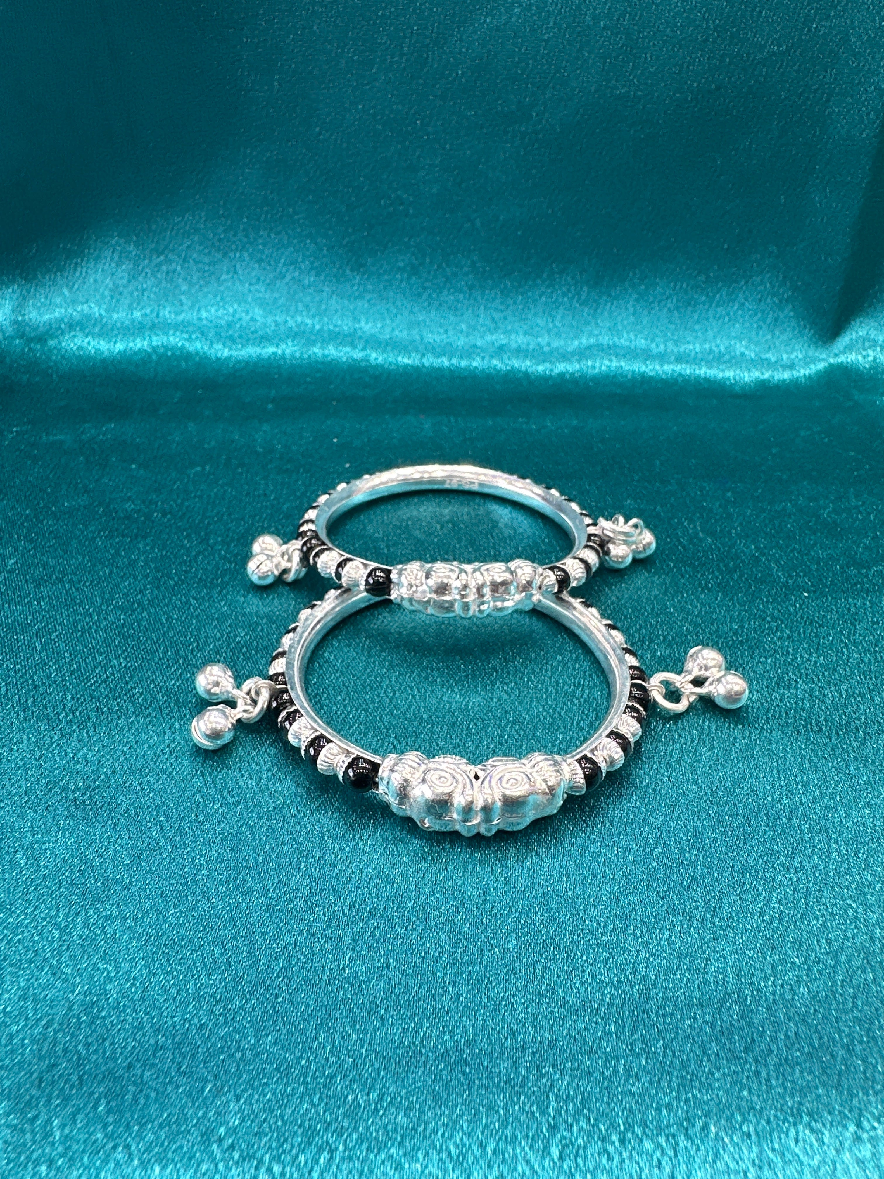Silver baby bangles with black beads and bells