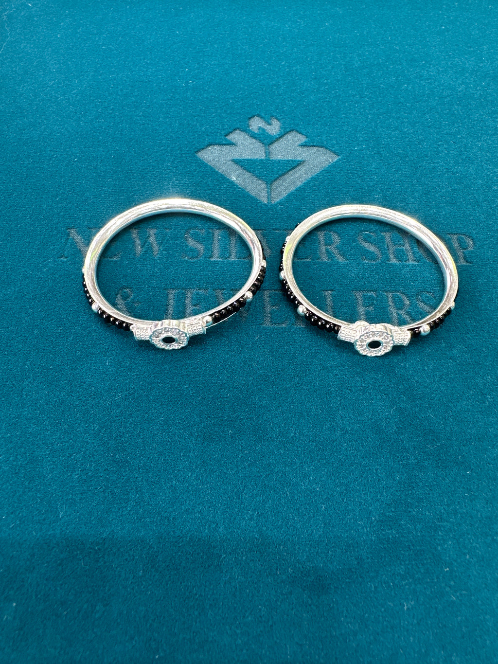 Silver baby bangles with black beads