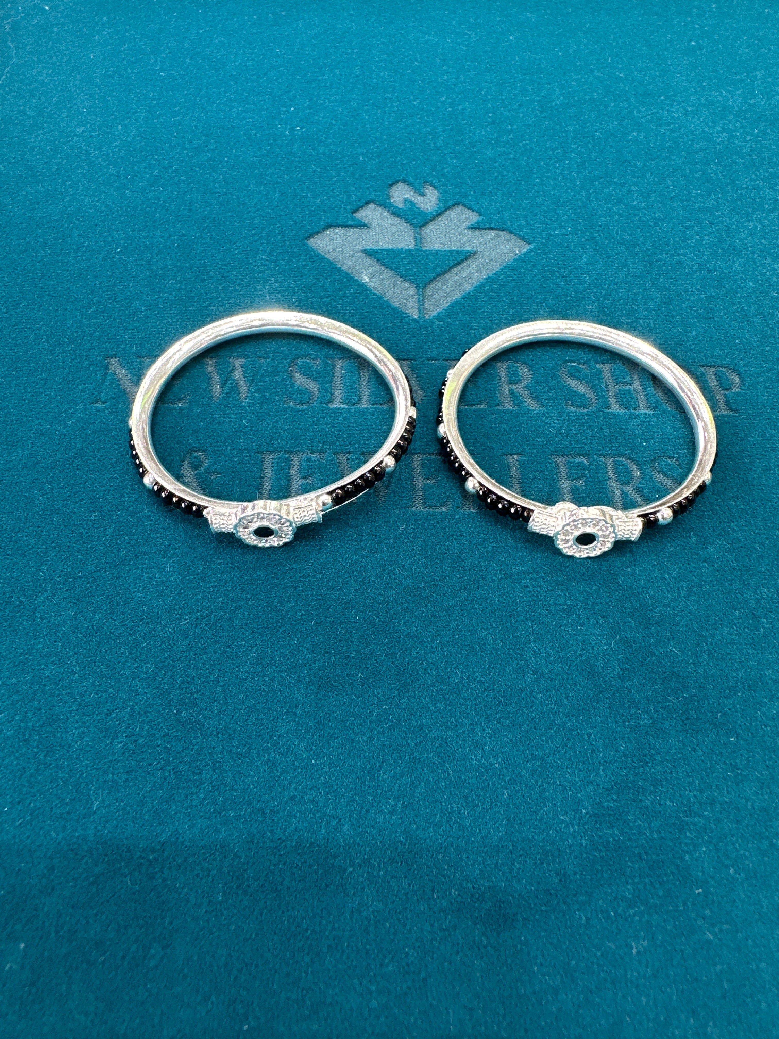 Silver baby bangles with black beads