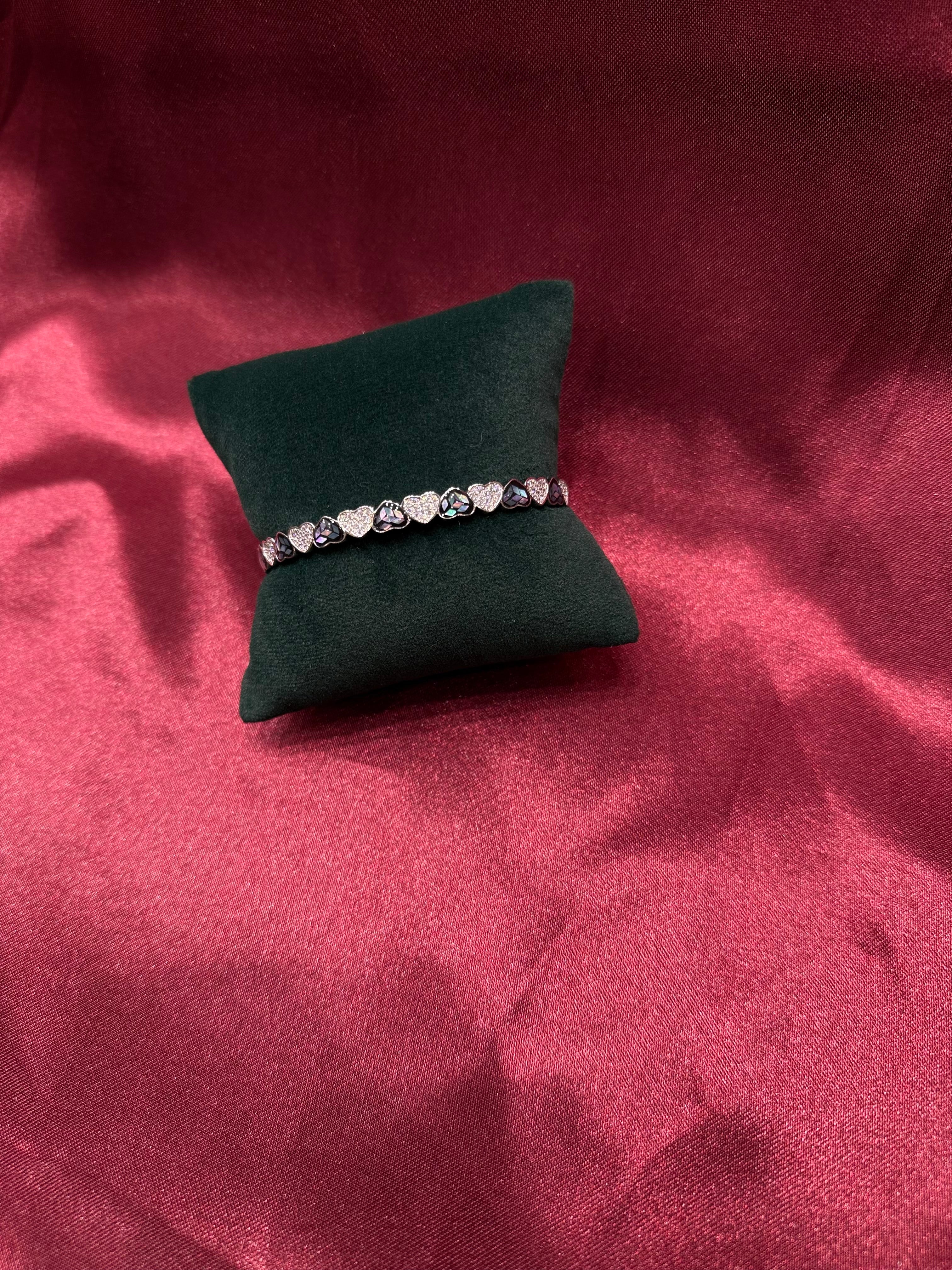 Fancy silver bangle with shimmering hearts