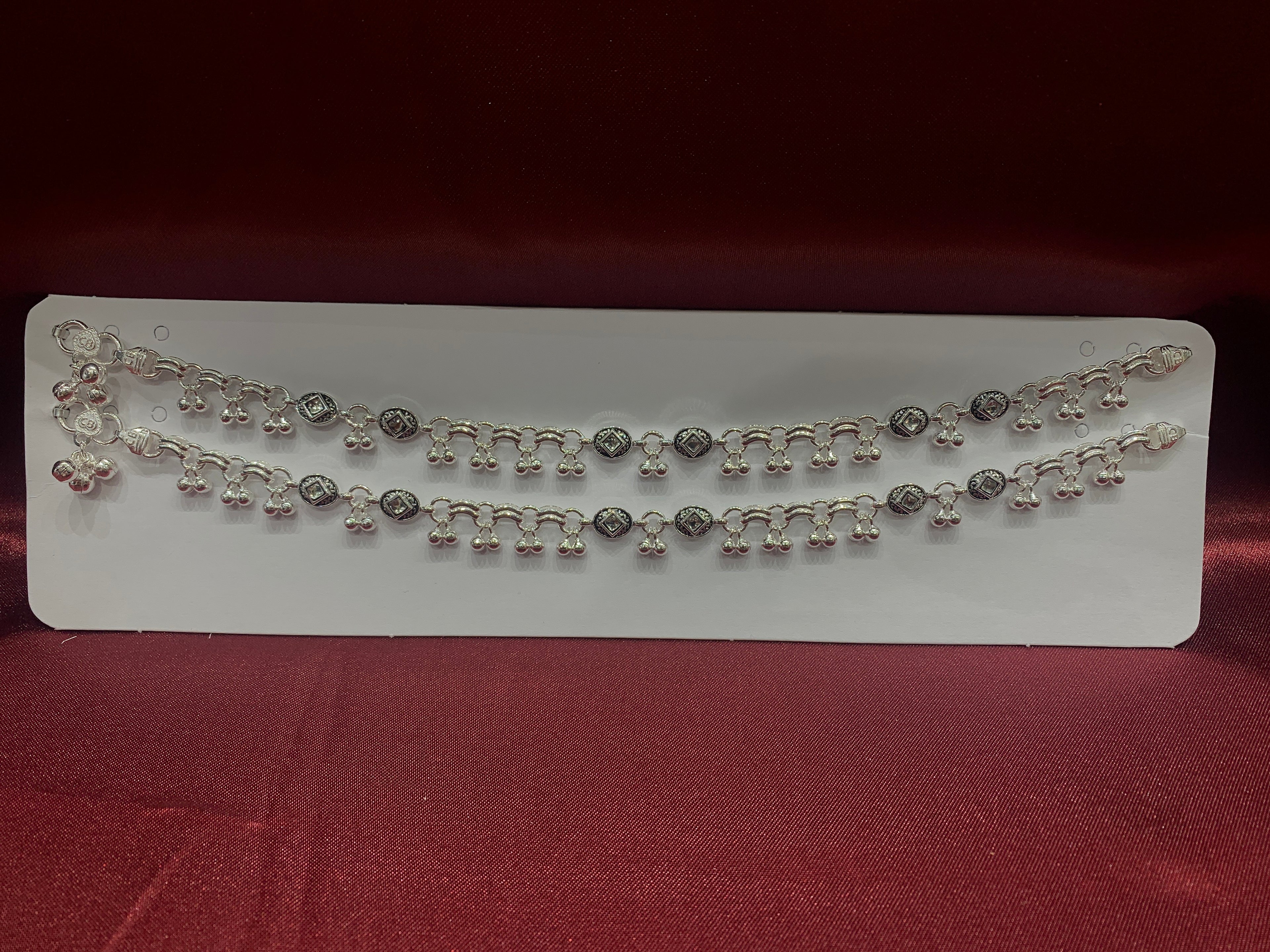 Fancy silver anklets with square stones in center and hanging bells