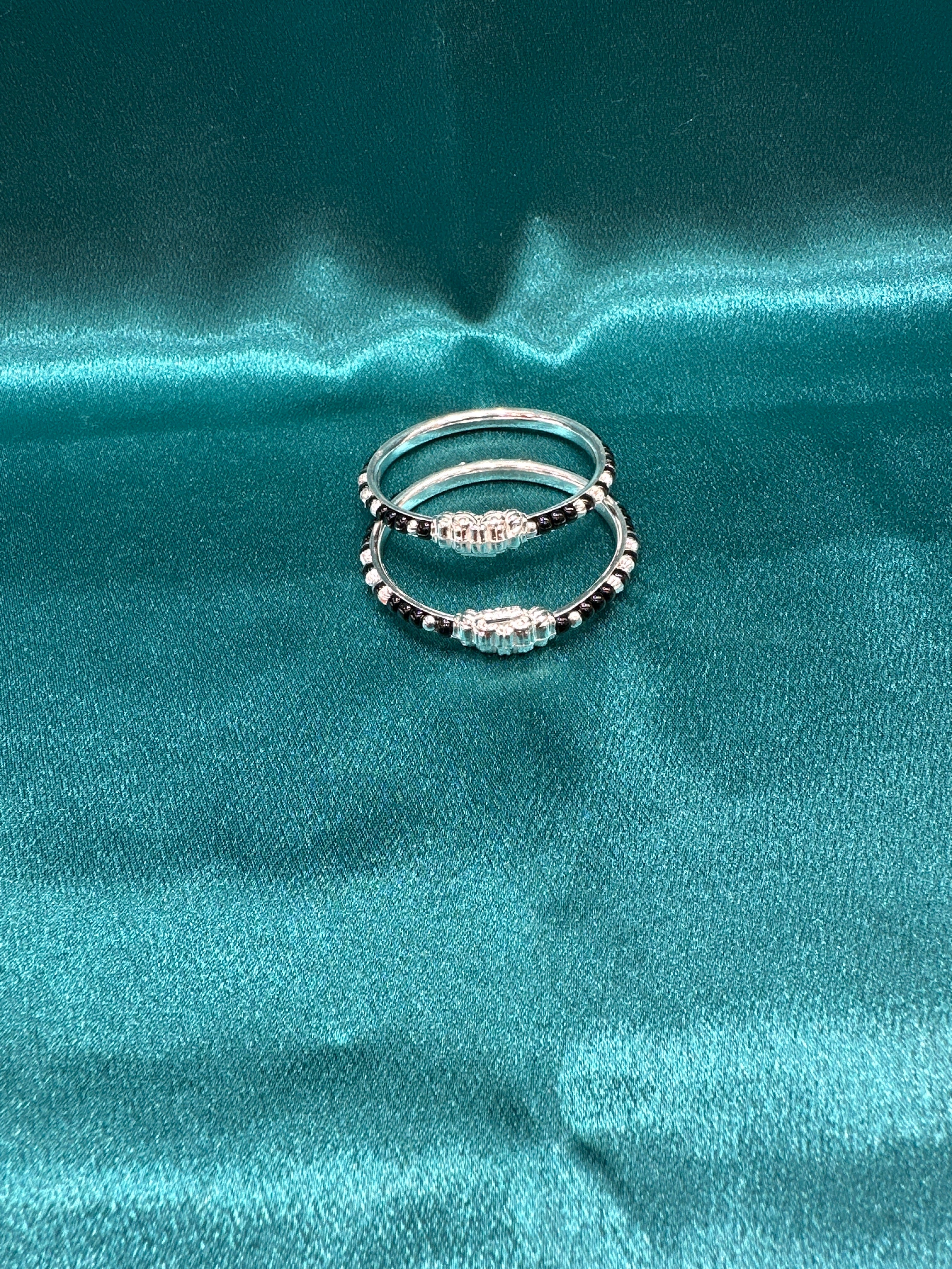 Silver baby bangles with black beads