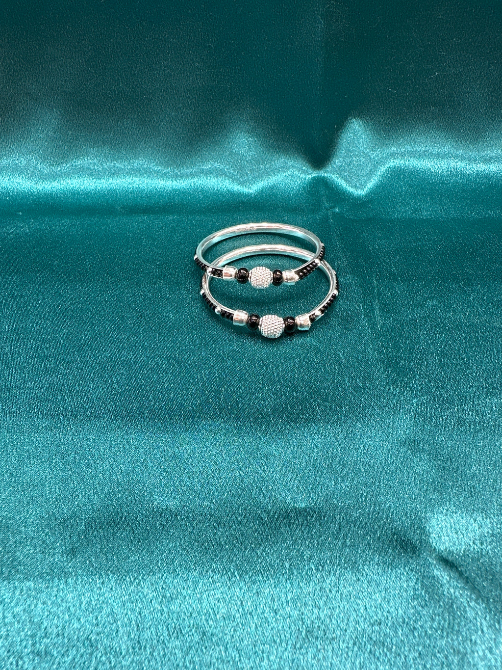 Silver baby bangles with black beads