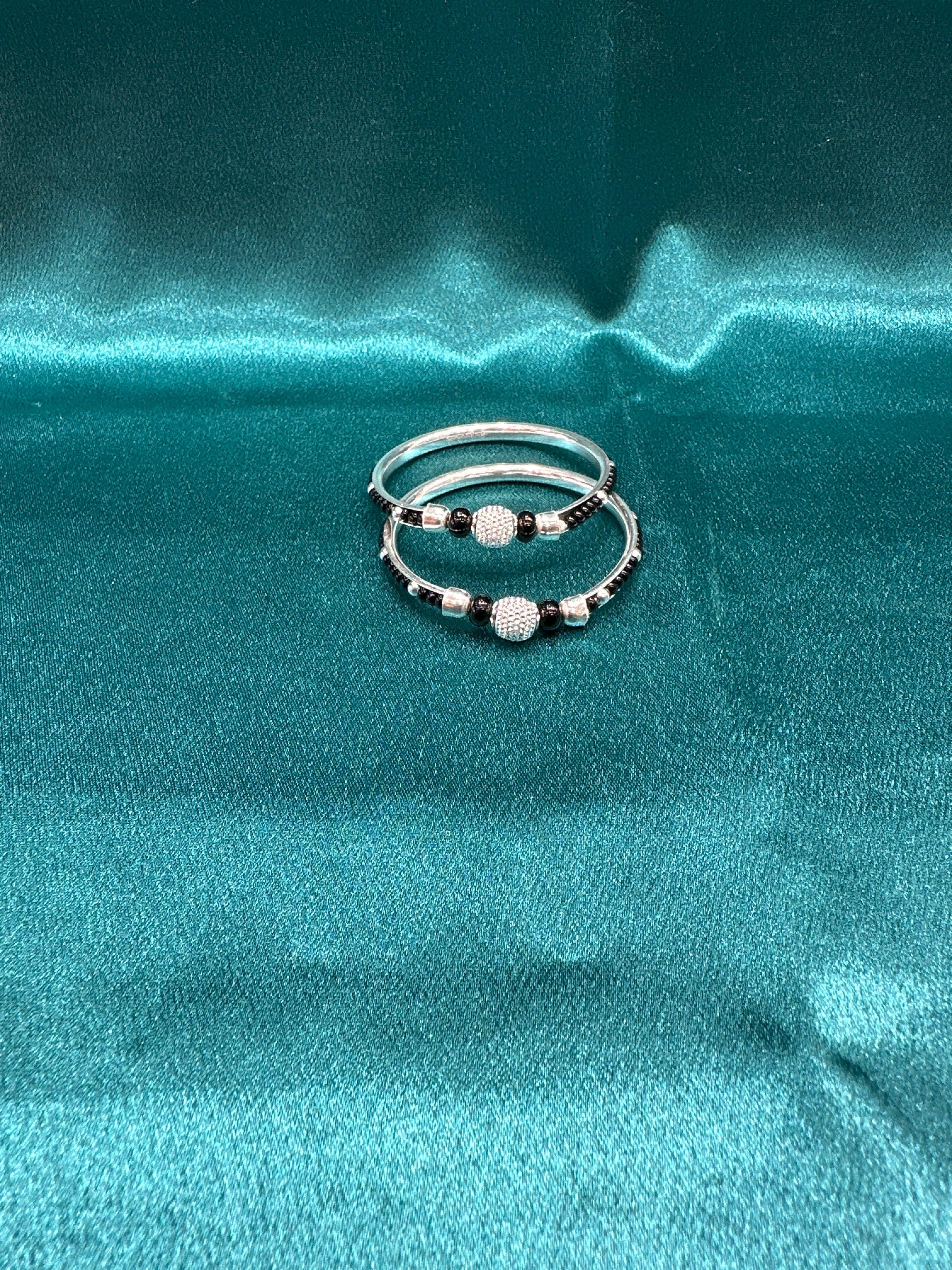 Silver baby bangles with black beads