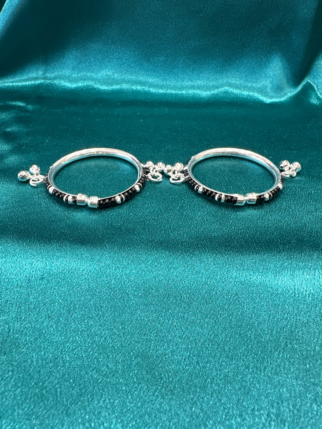 Silver baby bangles with black beads and bells