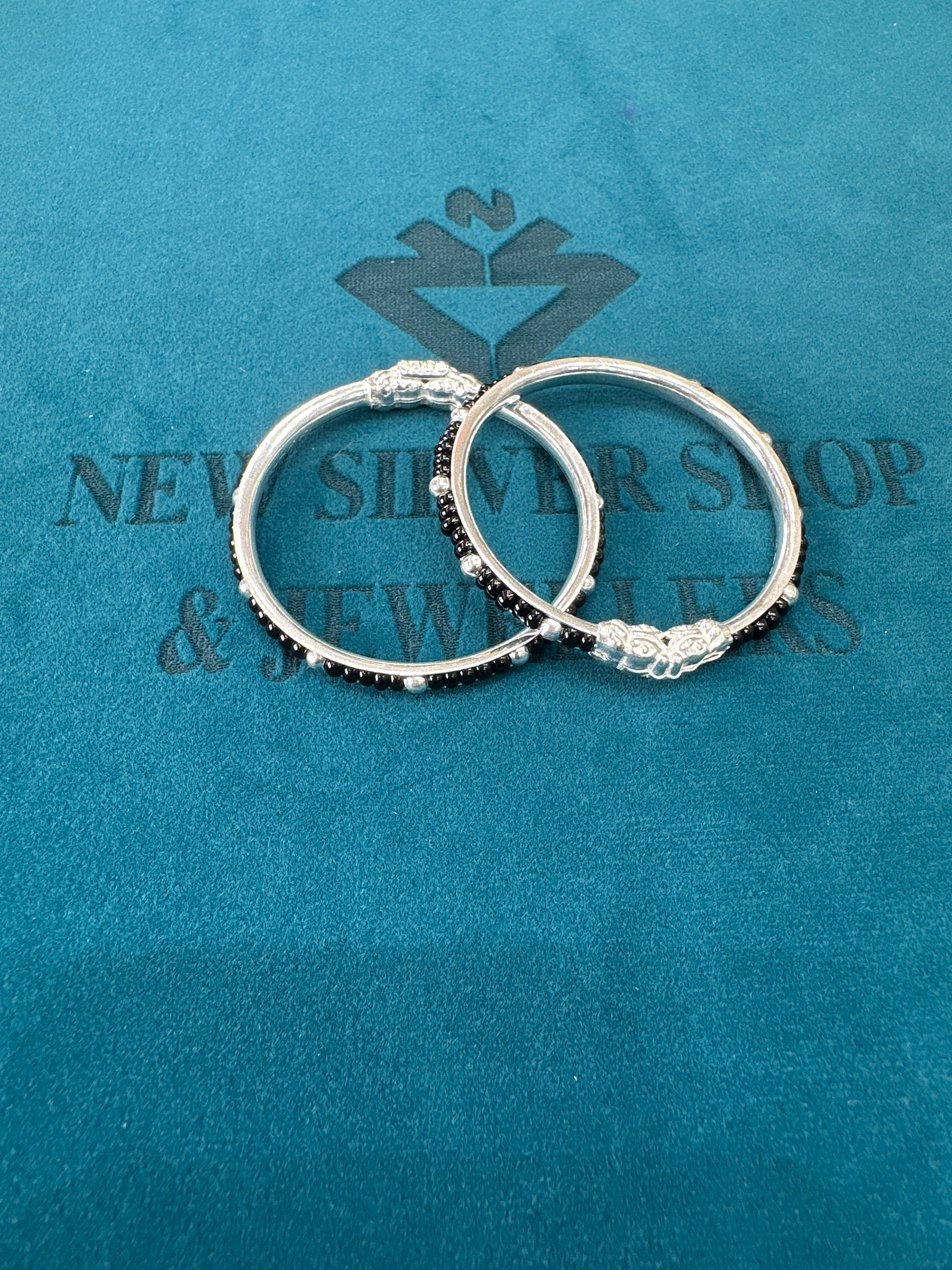 Silver baby bangles with black beads