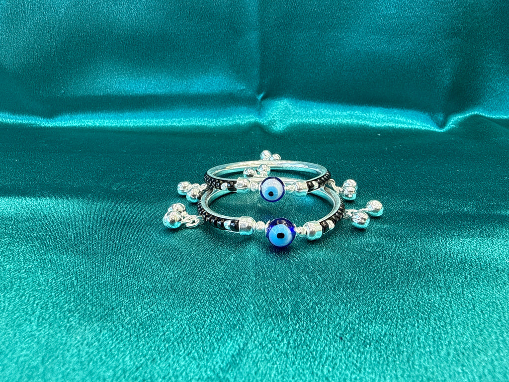 Silver baby bangles with black beads, evil eye and bells