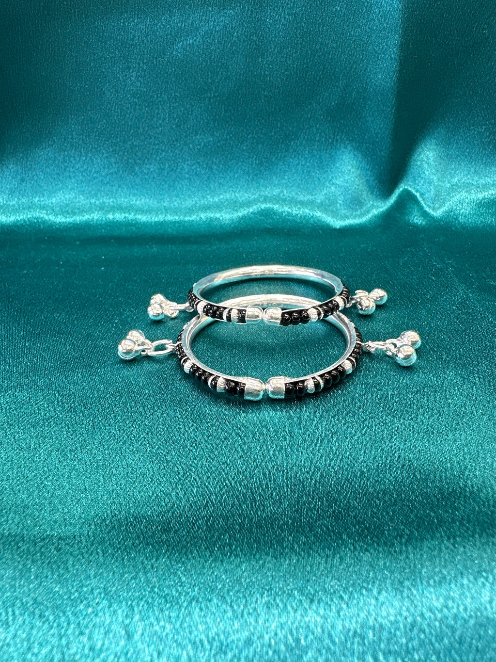 Silver baby bangles with black beads and bells
