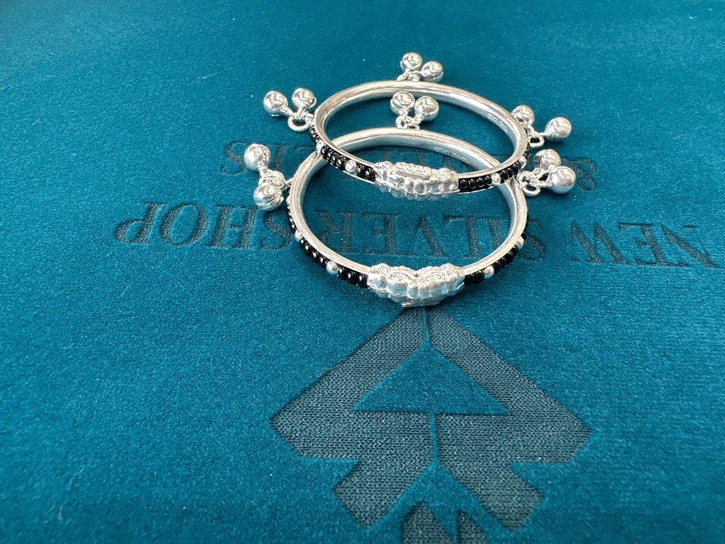 Silver baby bangles with black beads and bells