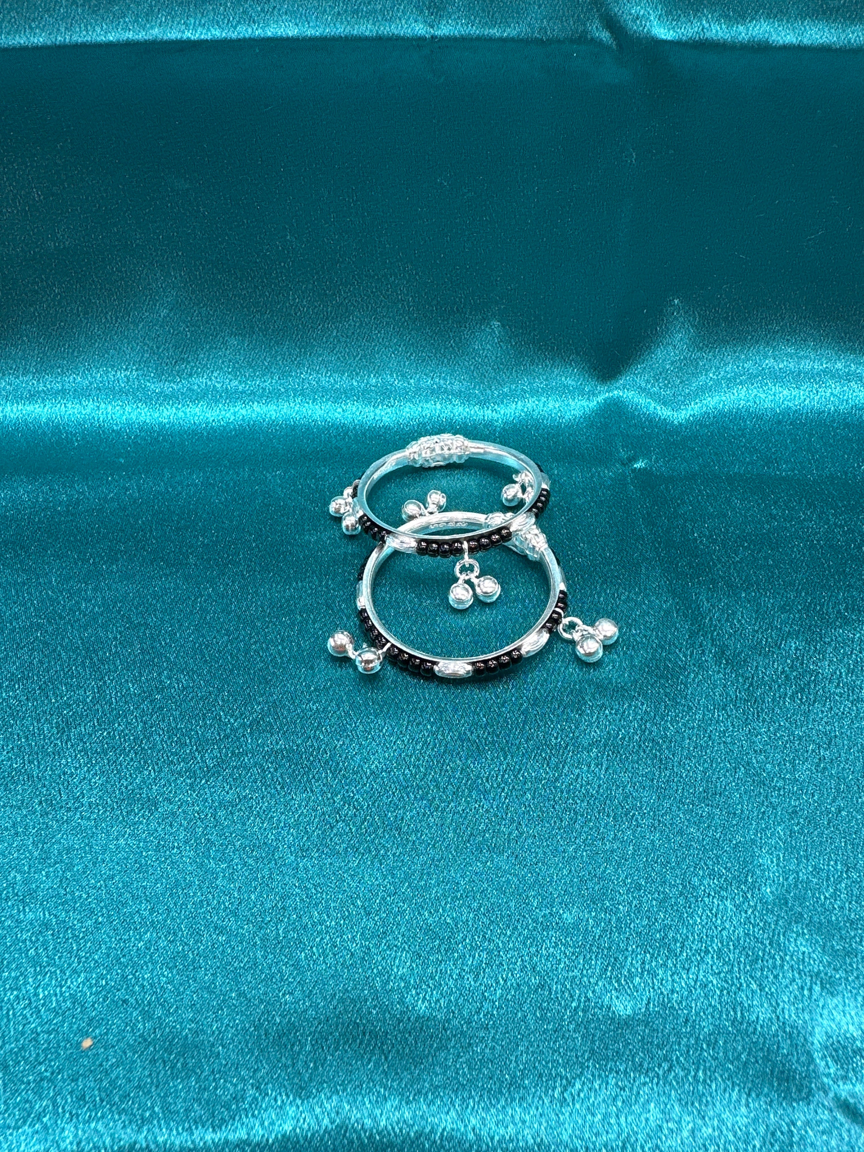 Silver baby bangles with black beads and bells