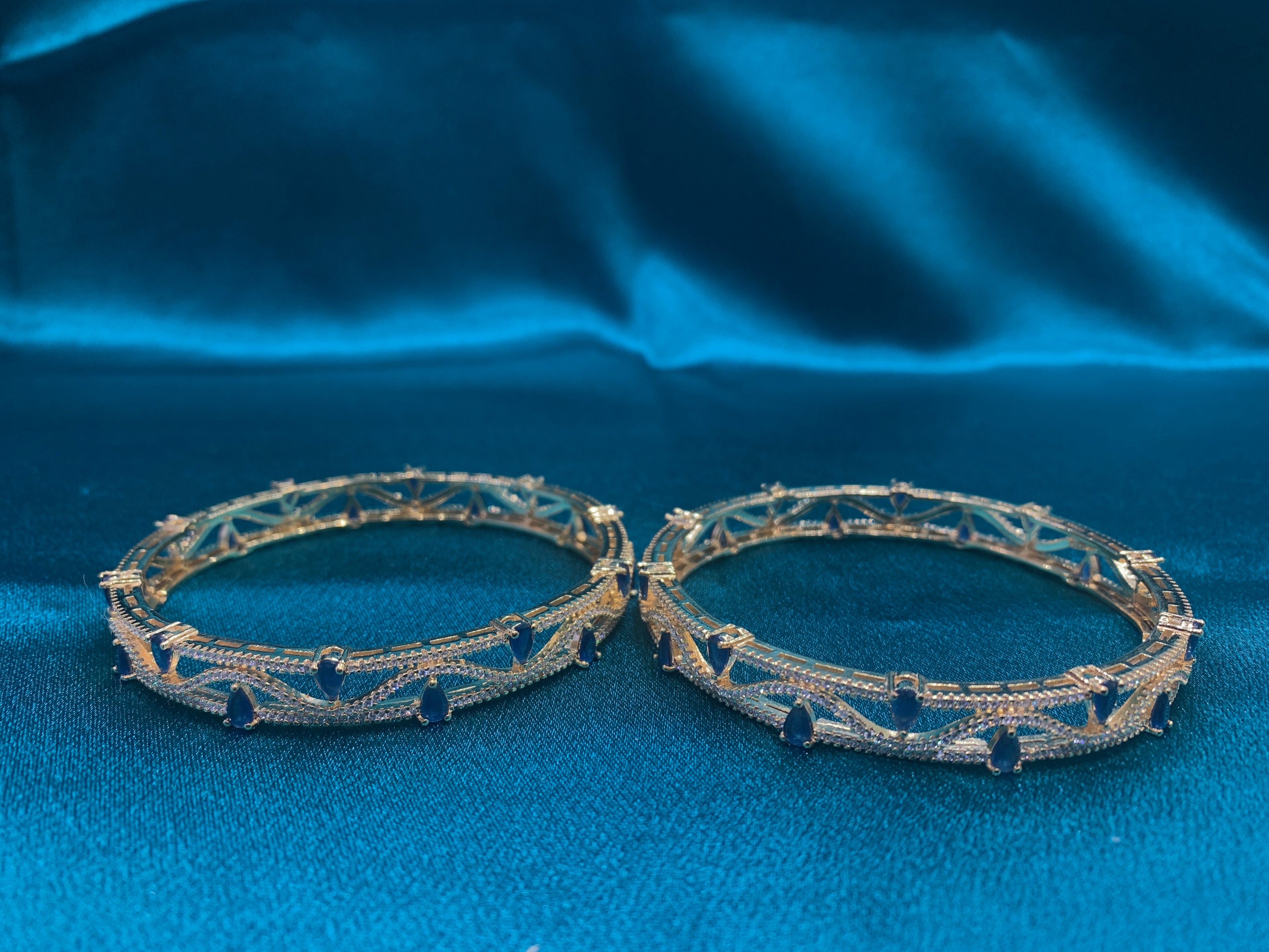 Dazzling gold plated silver bangles with tear drop blue CZ diamonds