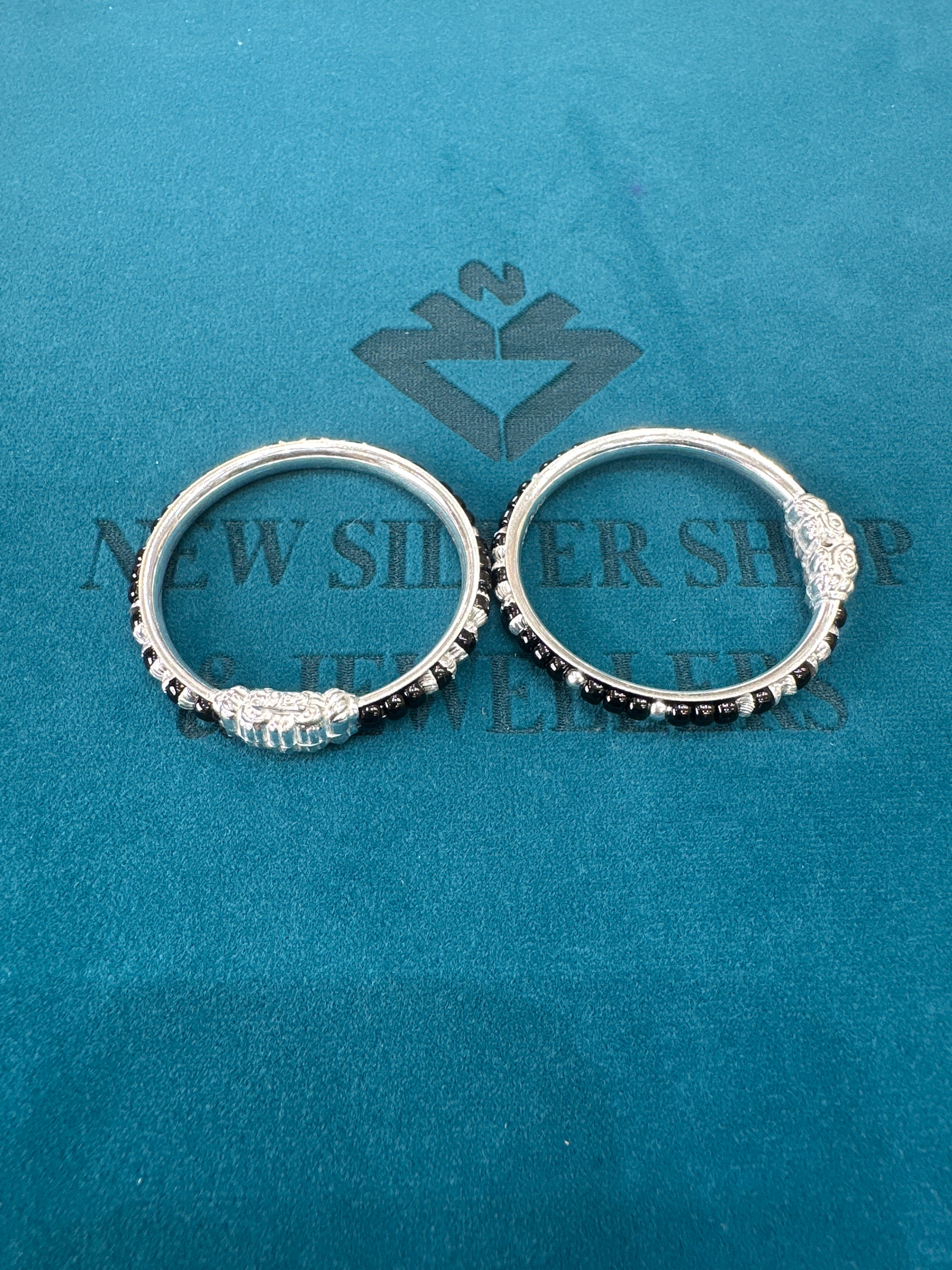 Silver baby bangles with black beads