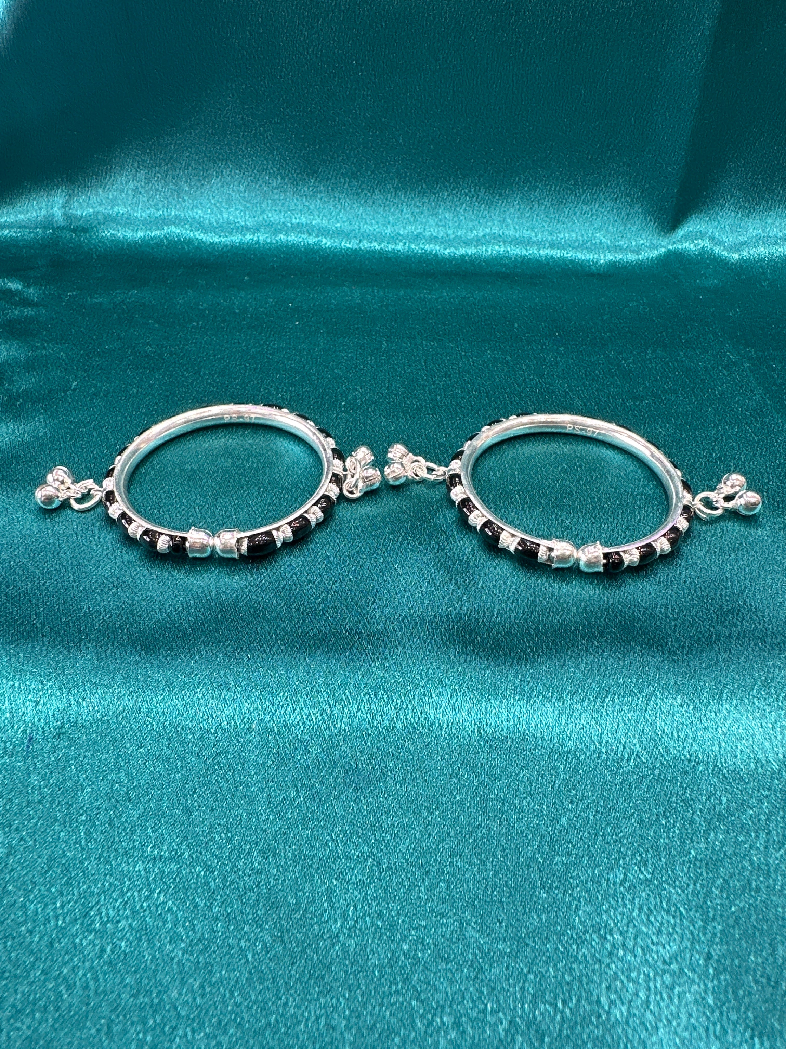 Silver baby bangles with black beads and bells
