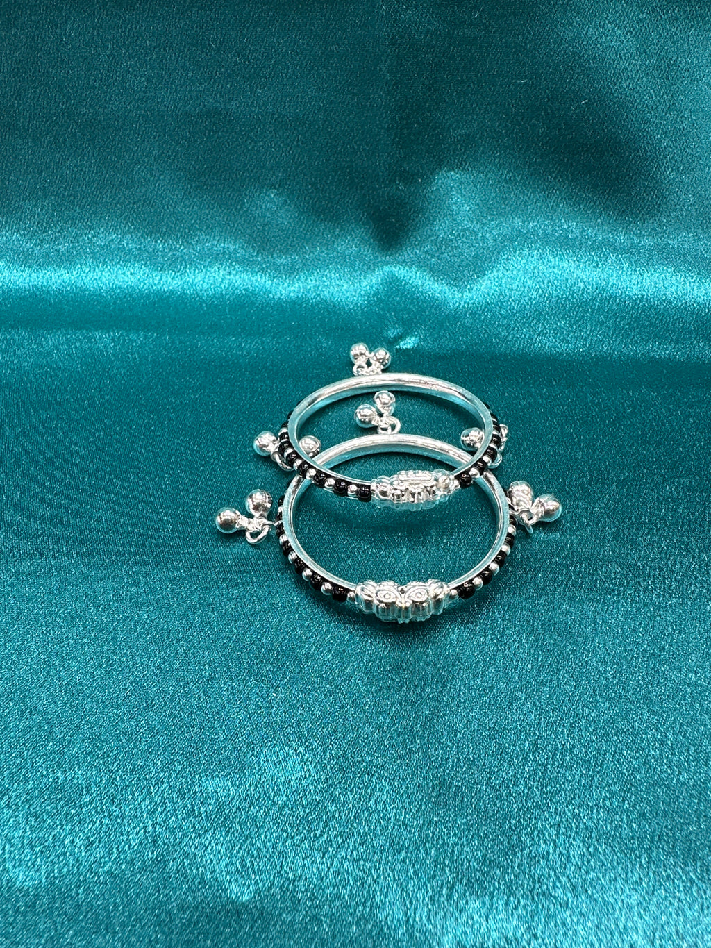 Silver baby bangles with black beads and bells