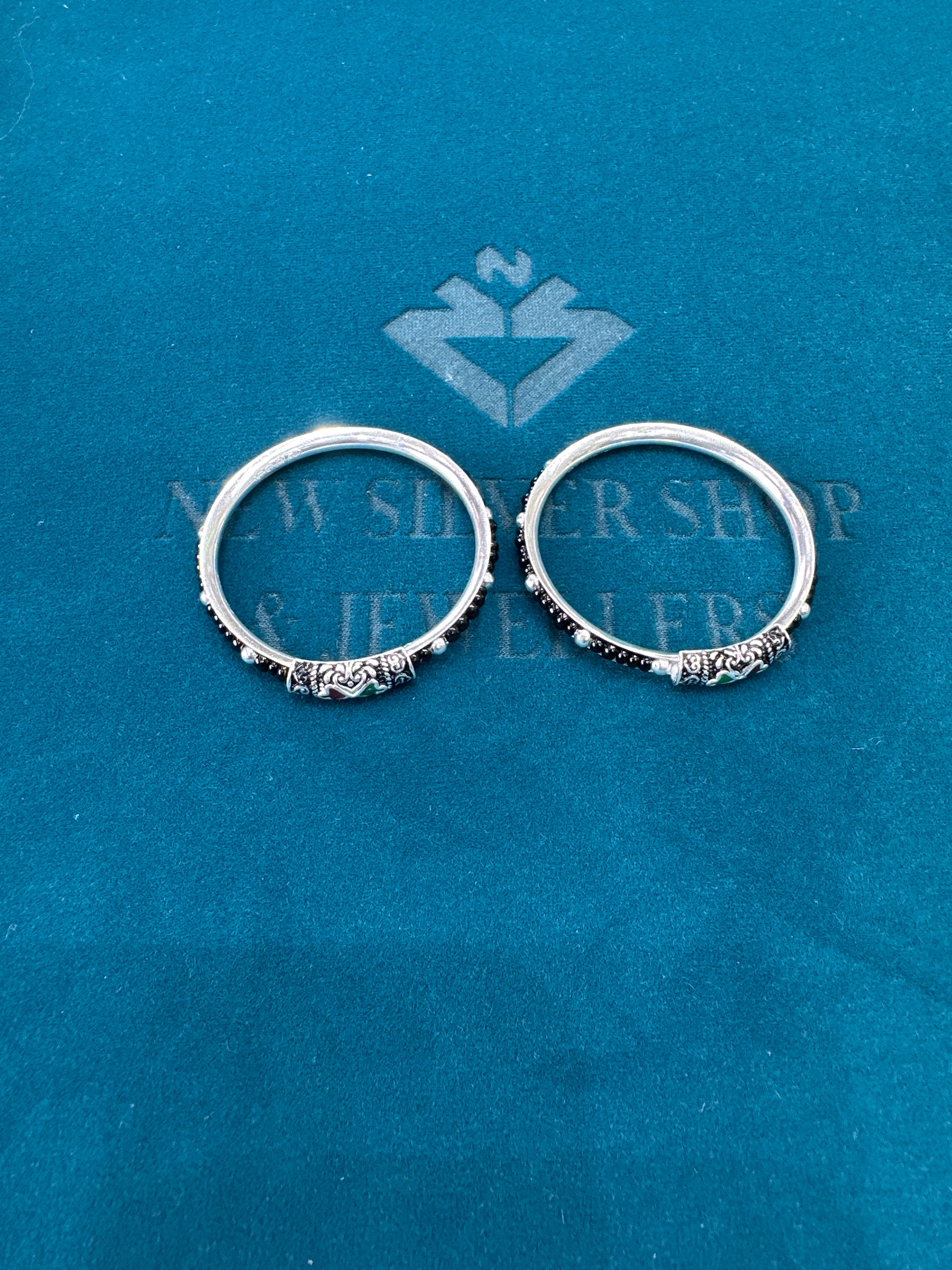 Silver baby bangles with black beads