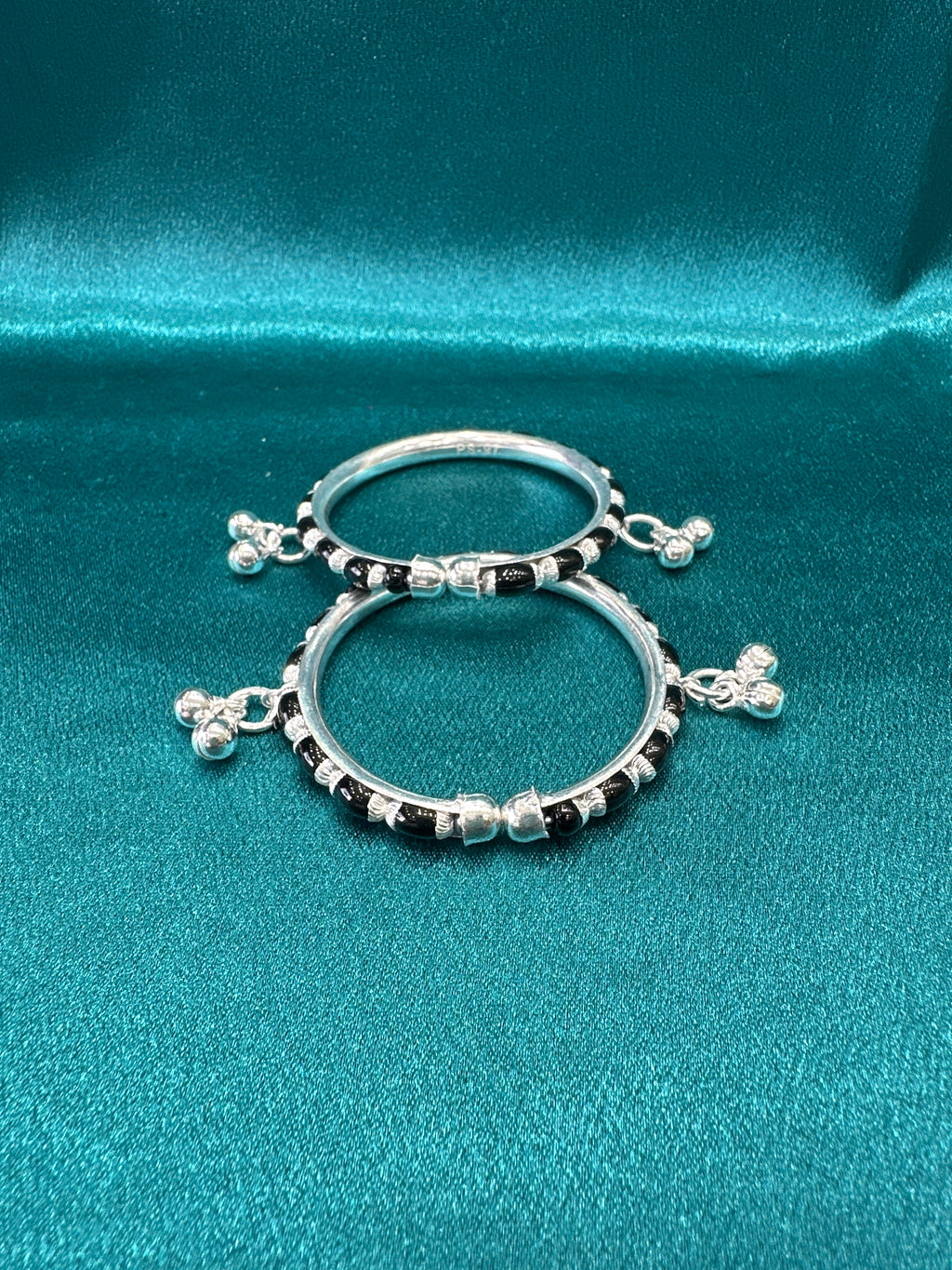 Silver baby bangles with black beads and bells