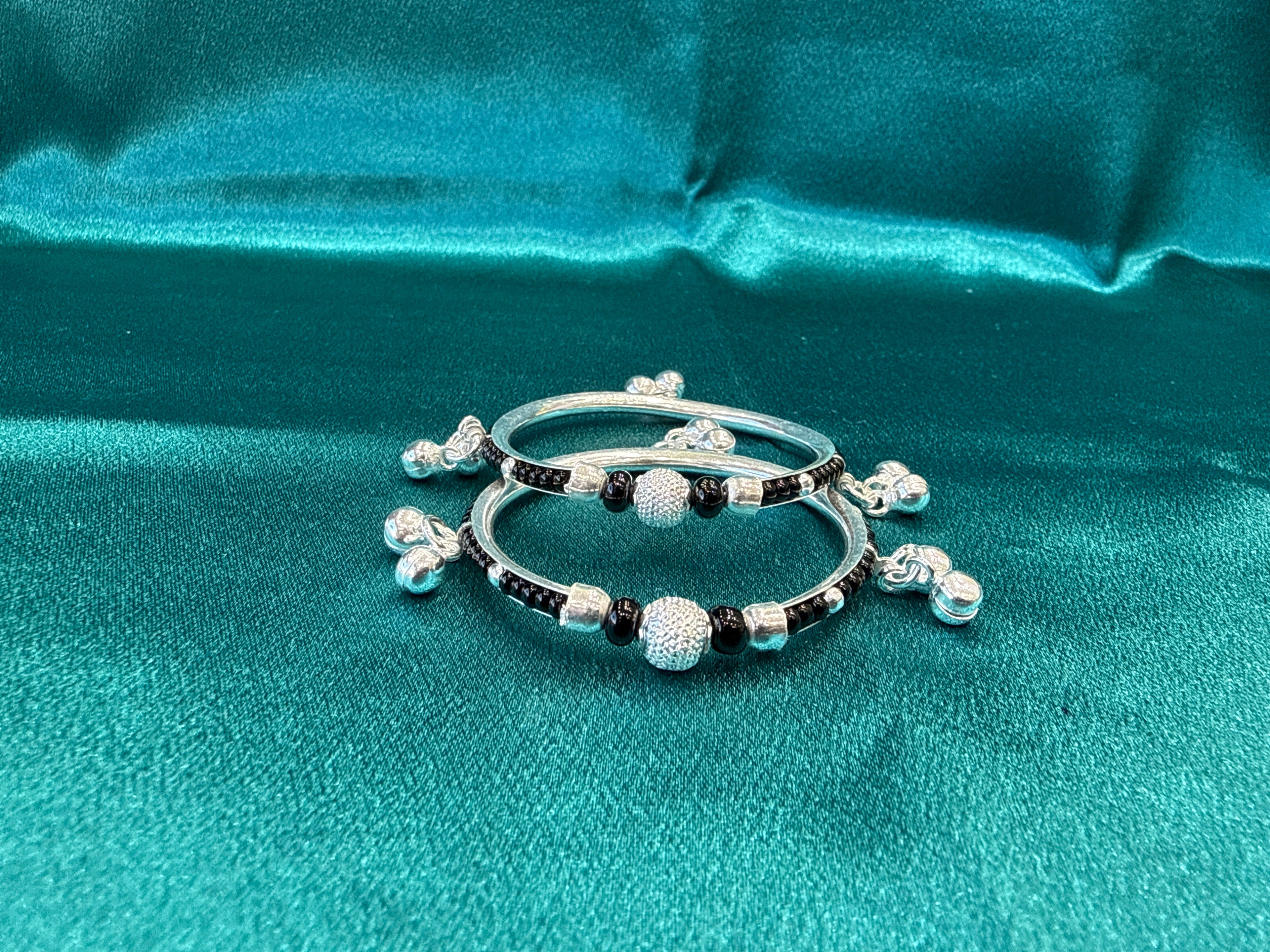 Silver baby bangles with black beads and bells BBB7