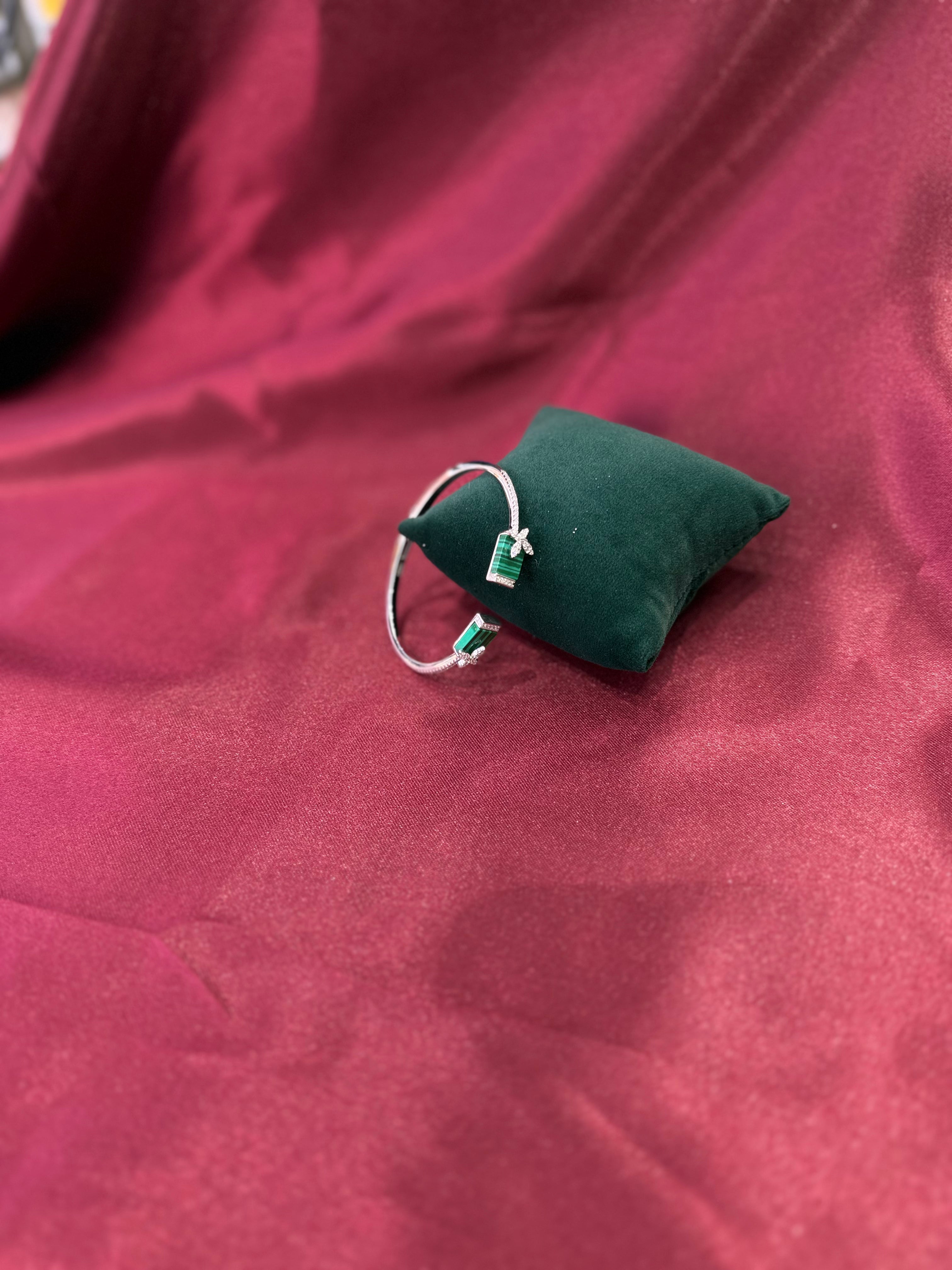 Fancy silver CZ diamond bangle with square green stones