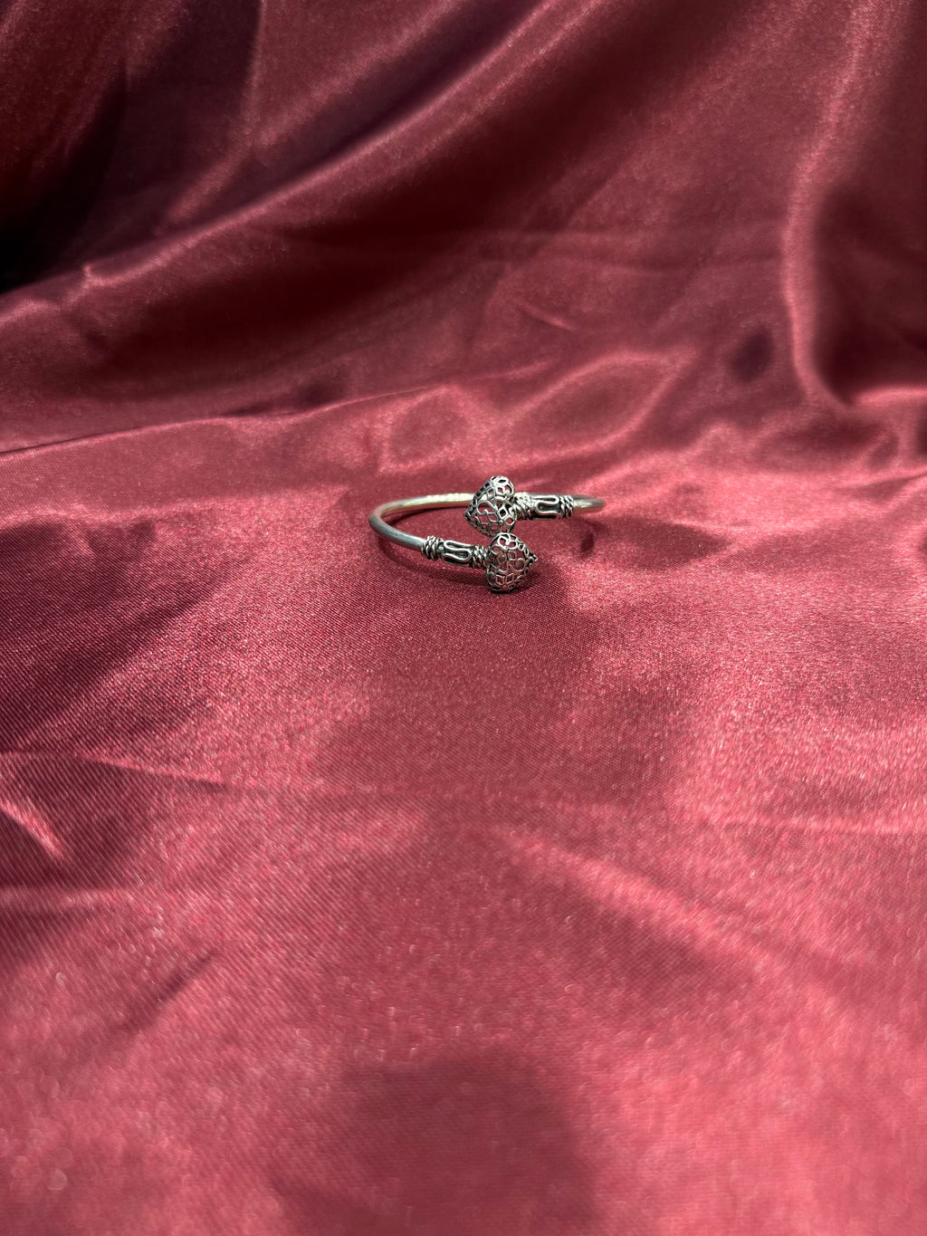 Fancy silver antique style open bangle with hearts at end