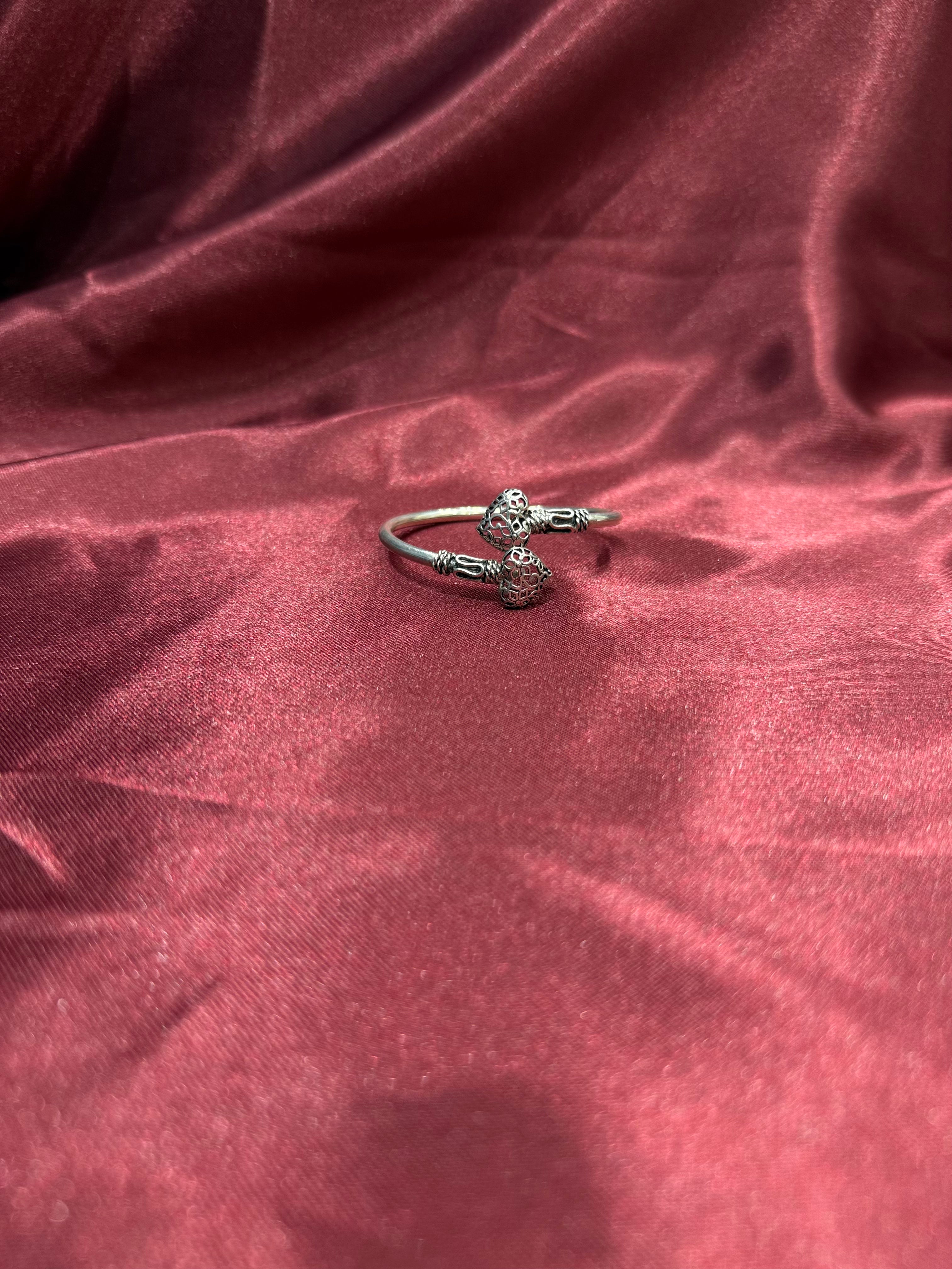 Fancy silver antique style open bangle with hearts at end